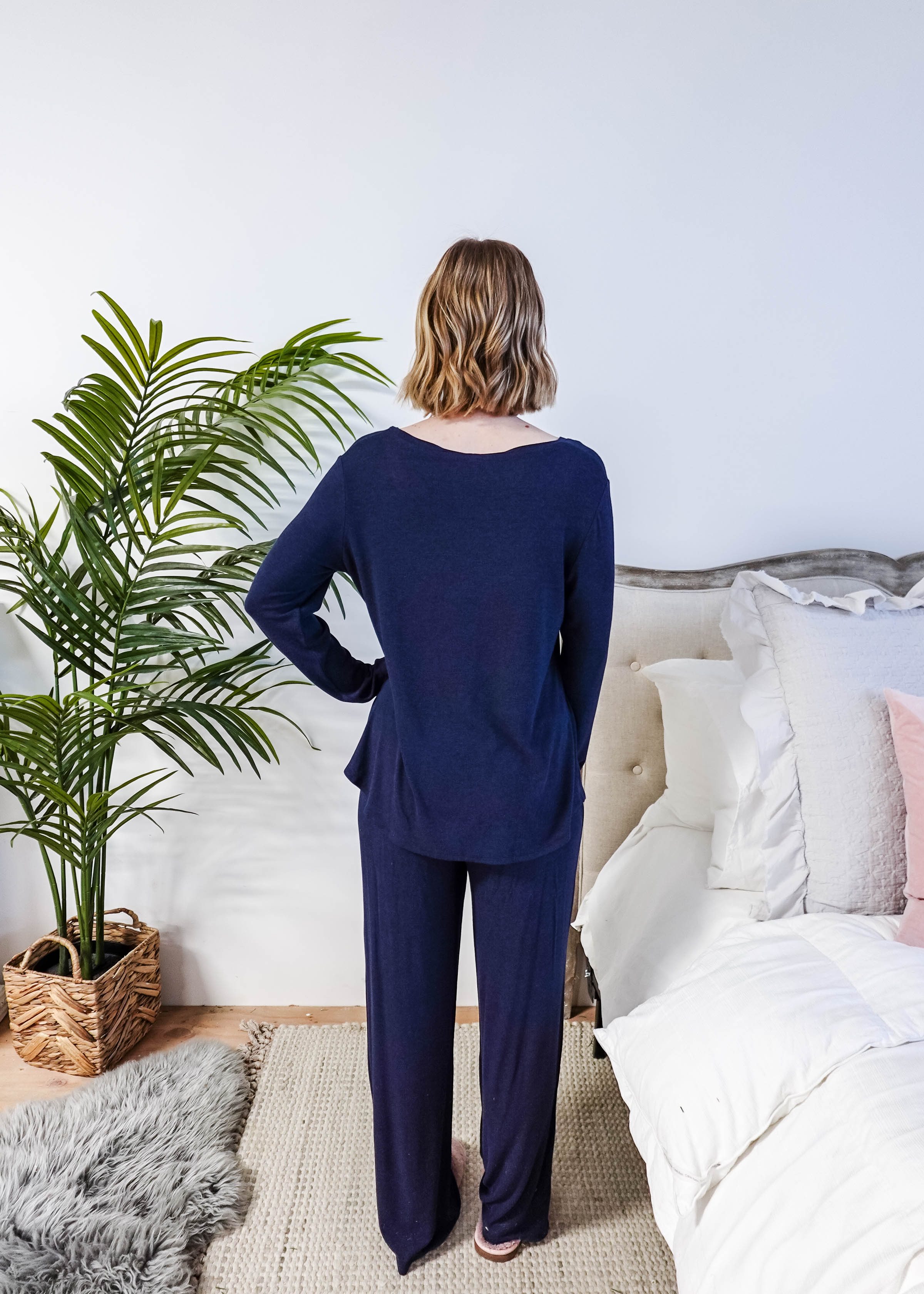Miranda wearing the Navy Melange Top Straight Pant Knit Lounge Set, highlighting the boat-neck top and flowy trousers.
Shot showing fit from the back