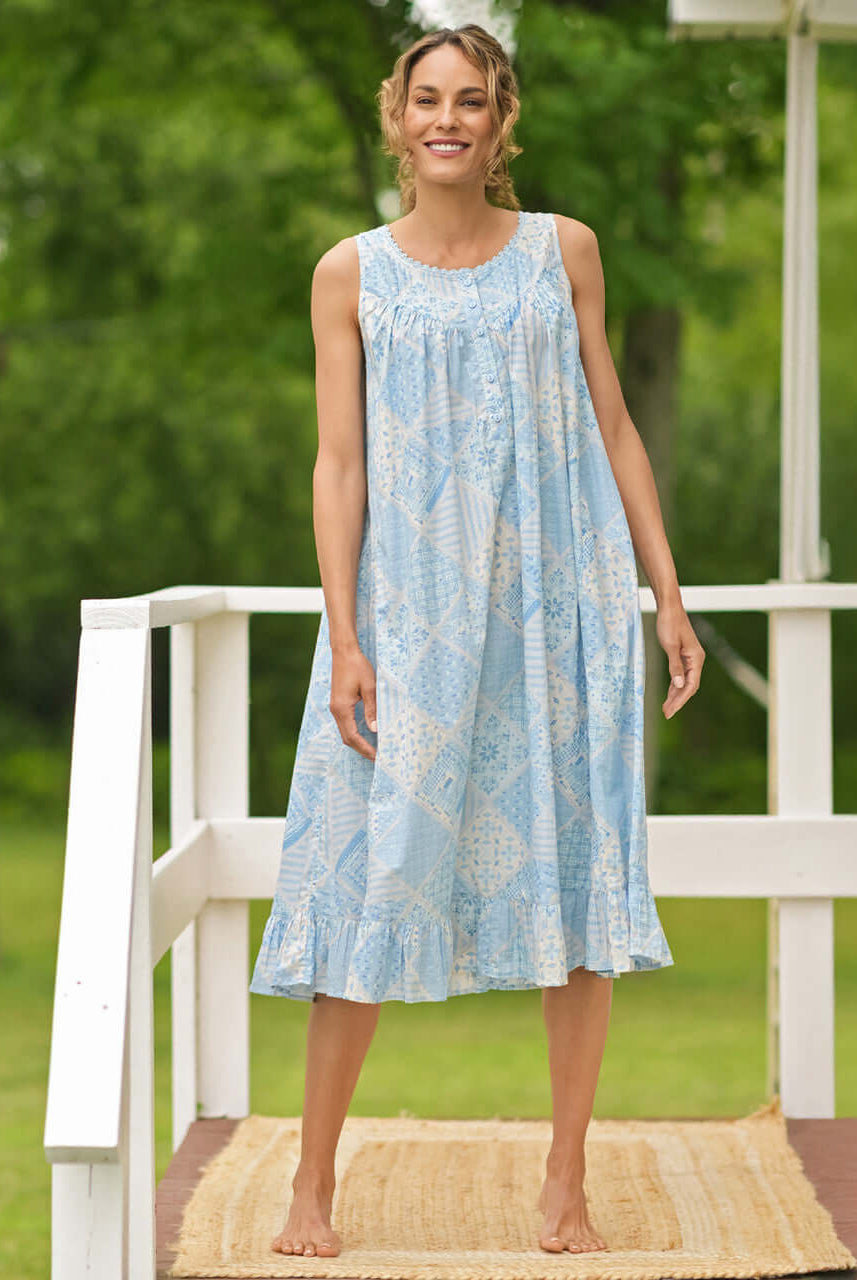 April Cornell Maddie’s Medley Cotton Nightgown – Embroidered Light Blue Sleeveless Nighty with Button Front. Worn by a model in a cottage/outdoor setting