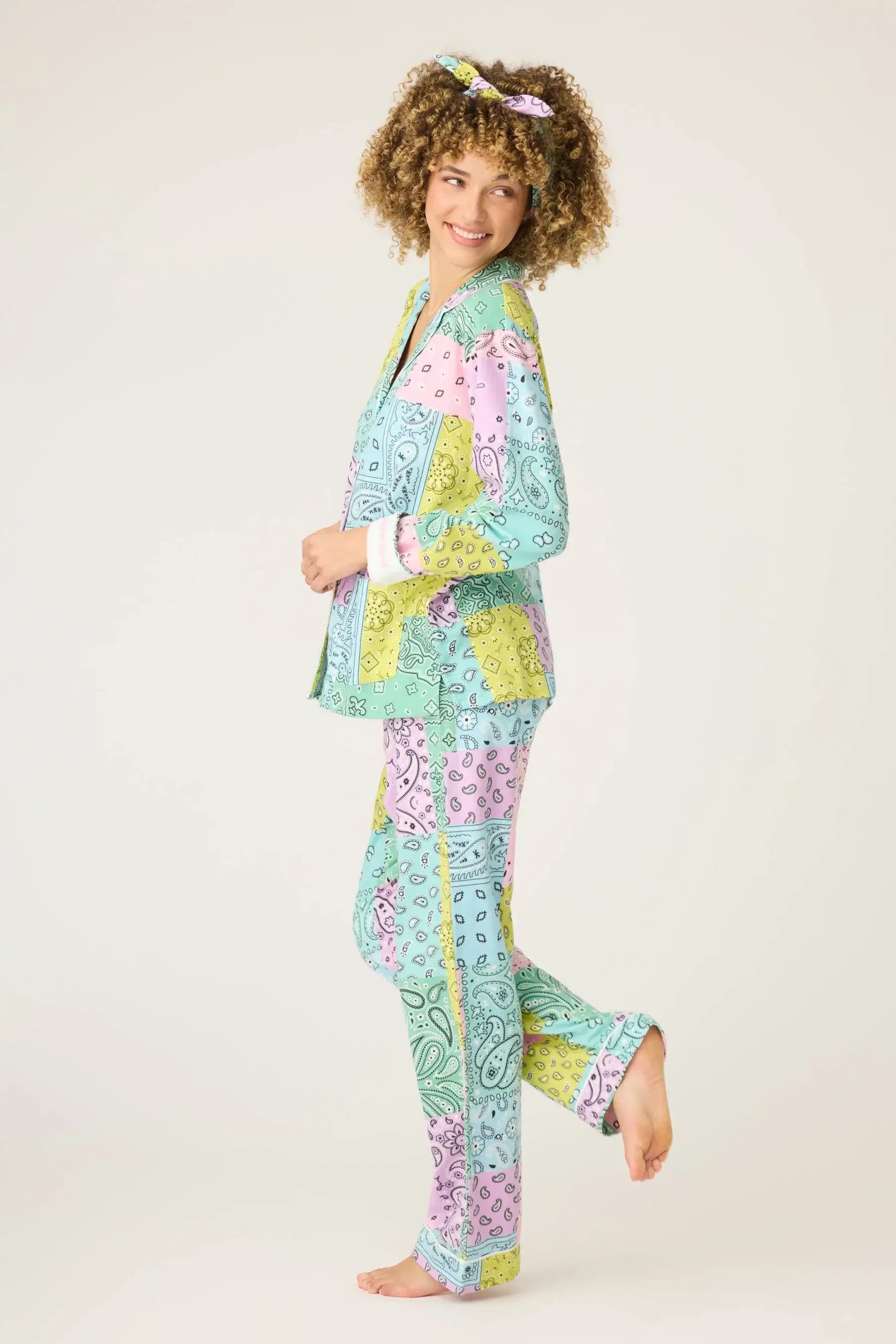 Model wearing Howdy Honey Paisley Print Flannel PJ Set from PJ Salvage, showcasing vibrant pastel colors and playful patterns.