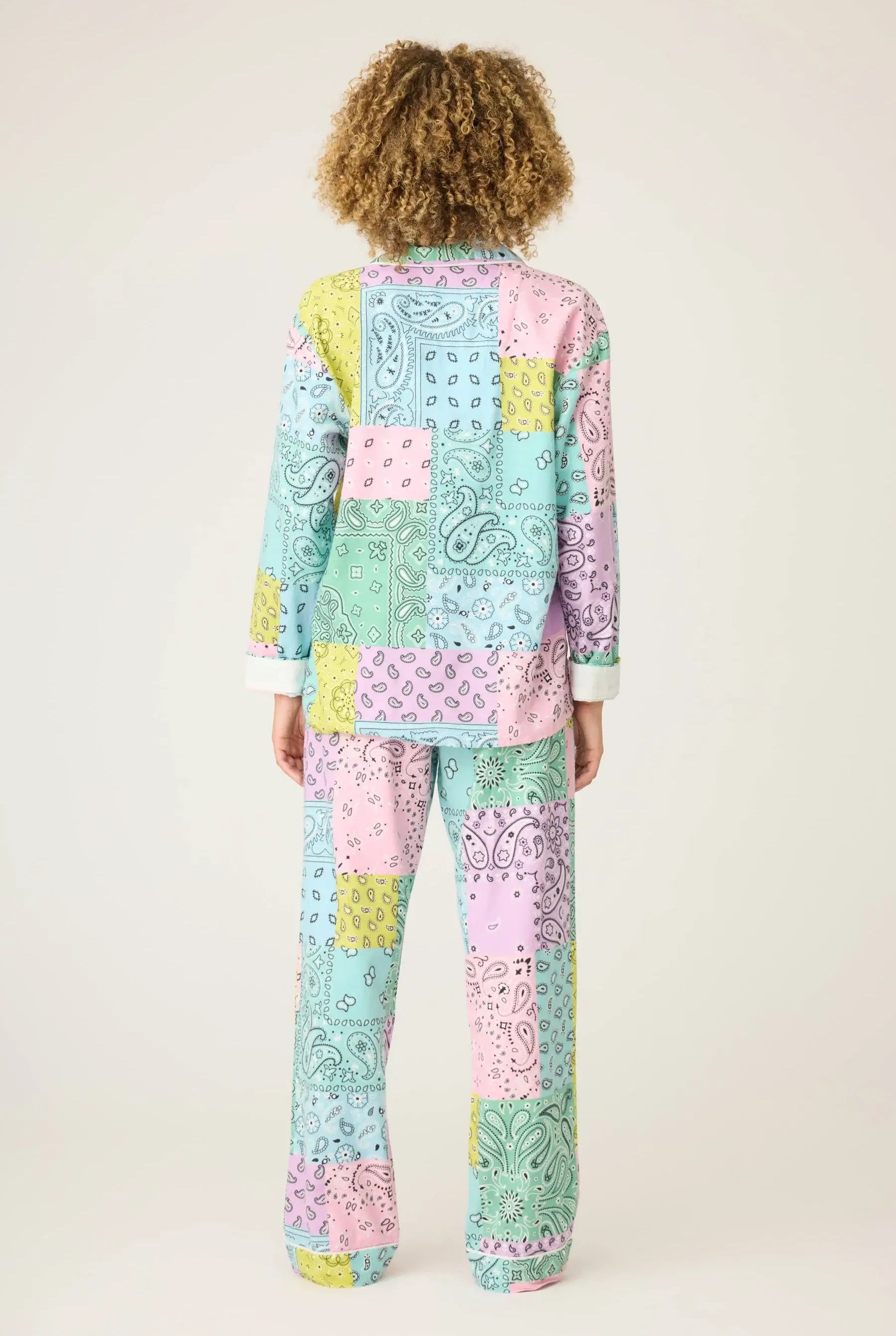 Back view of a model wearing the Howdy Honey Paisley Print Flannel PJ Set from PJ Salvage in pastel colors.