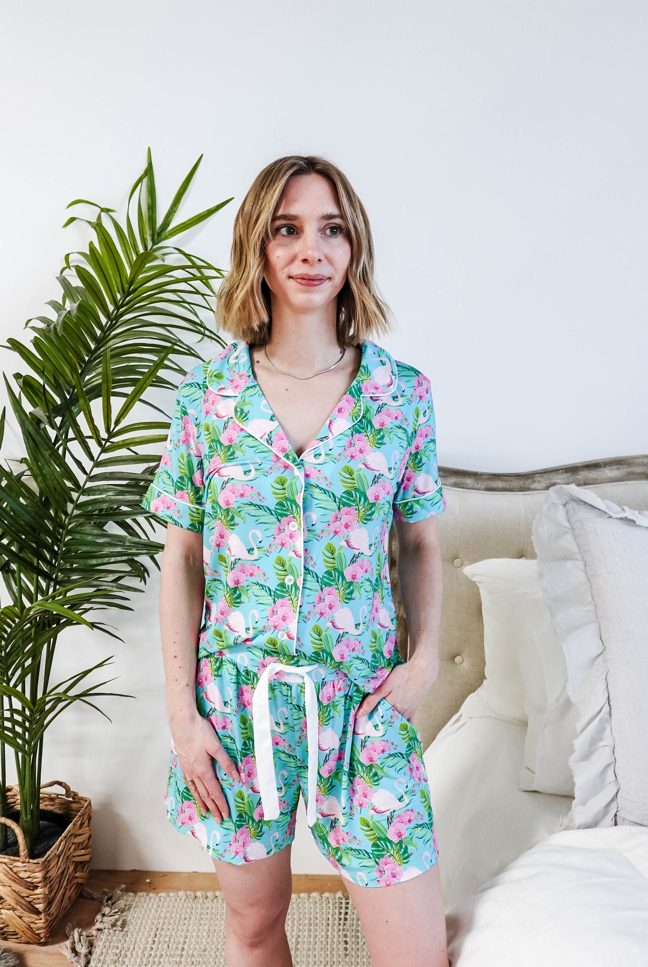 Tropic Like It's Hot Bamboo Short Sleeve Pajama Set worn by a model, featuring pink flamingos and tropical orchids.