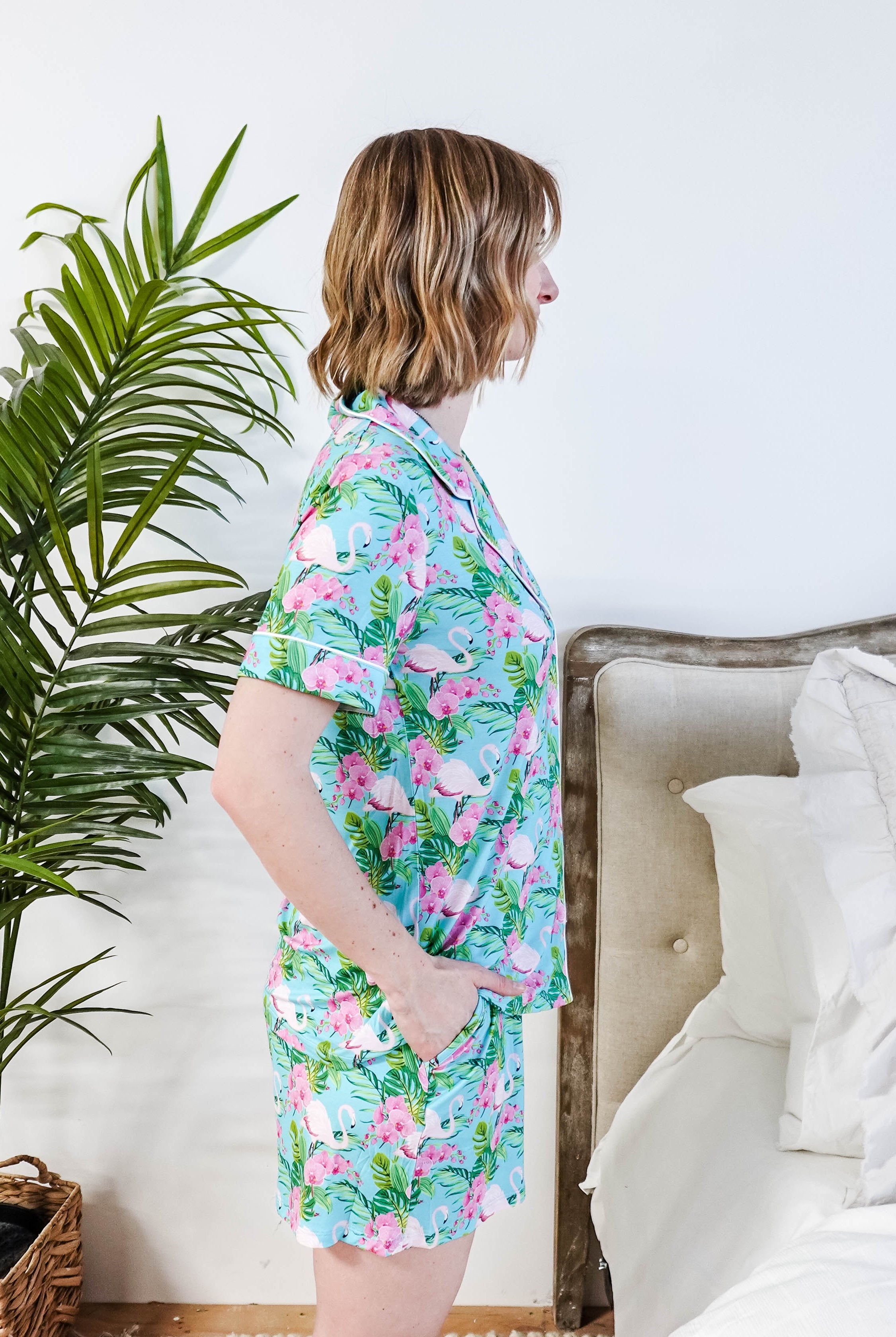 Side view of a model in Tropic Like It's Hot Bamboo Short Sleeve Pajama Set by Georgia Rylan with a tropical print.