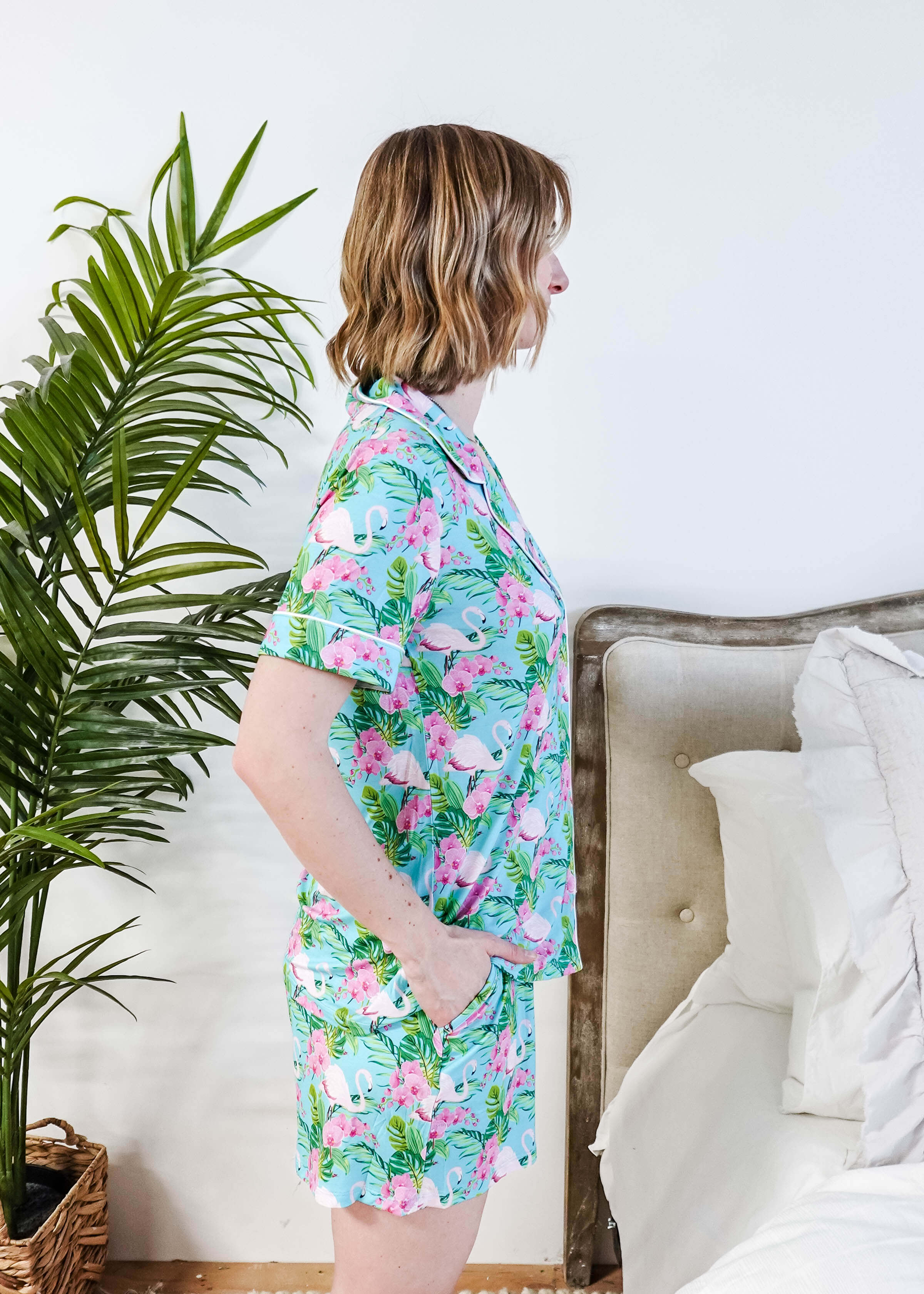 Side view of a model in Tropic Like It's Hot Bamboo Short Sleeve Pajama Set by Georgia Rylan with a tropical print.