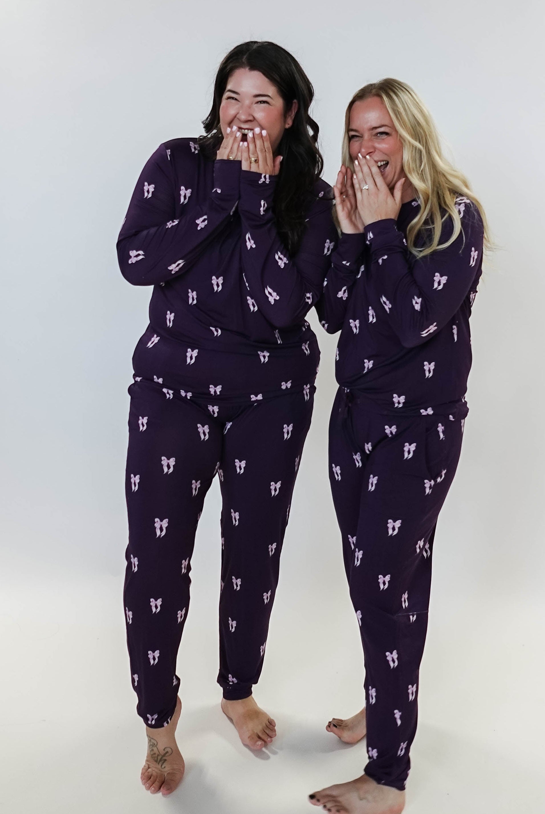 Purple Bows Print Long Sleeve & Jogger Bamboo PJ Set - two models wearing the set and sharing a giggle