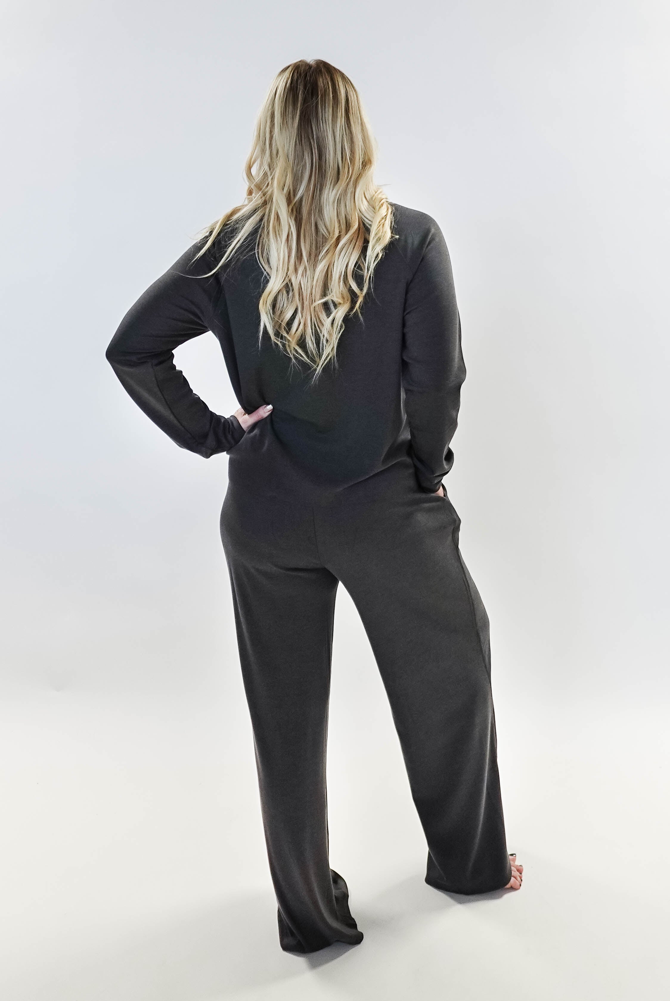 Model wearing Long Sleeve Raw Edge Straight Pant Lounge Set from the back, showcasing its relaxed fit and stylish design.