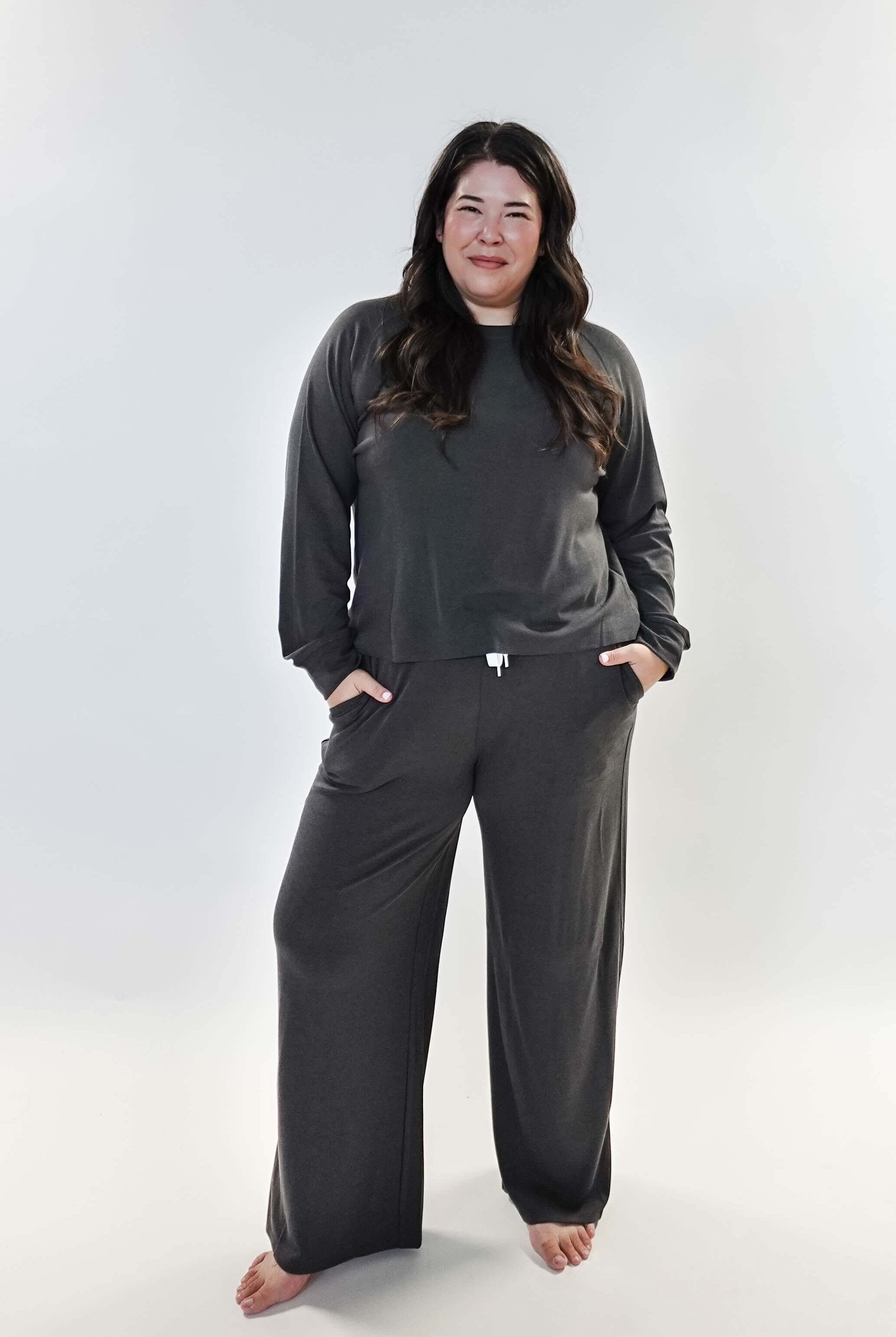 Model wearing the Long Sleeve Raw Edge Straight Pant Lounge Set in gray, featuring a relaxed fit and pockets.