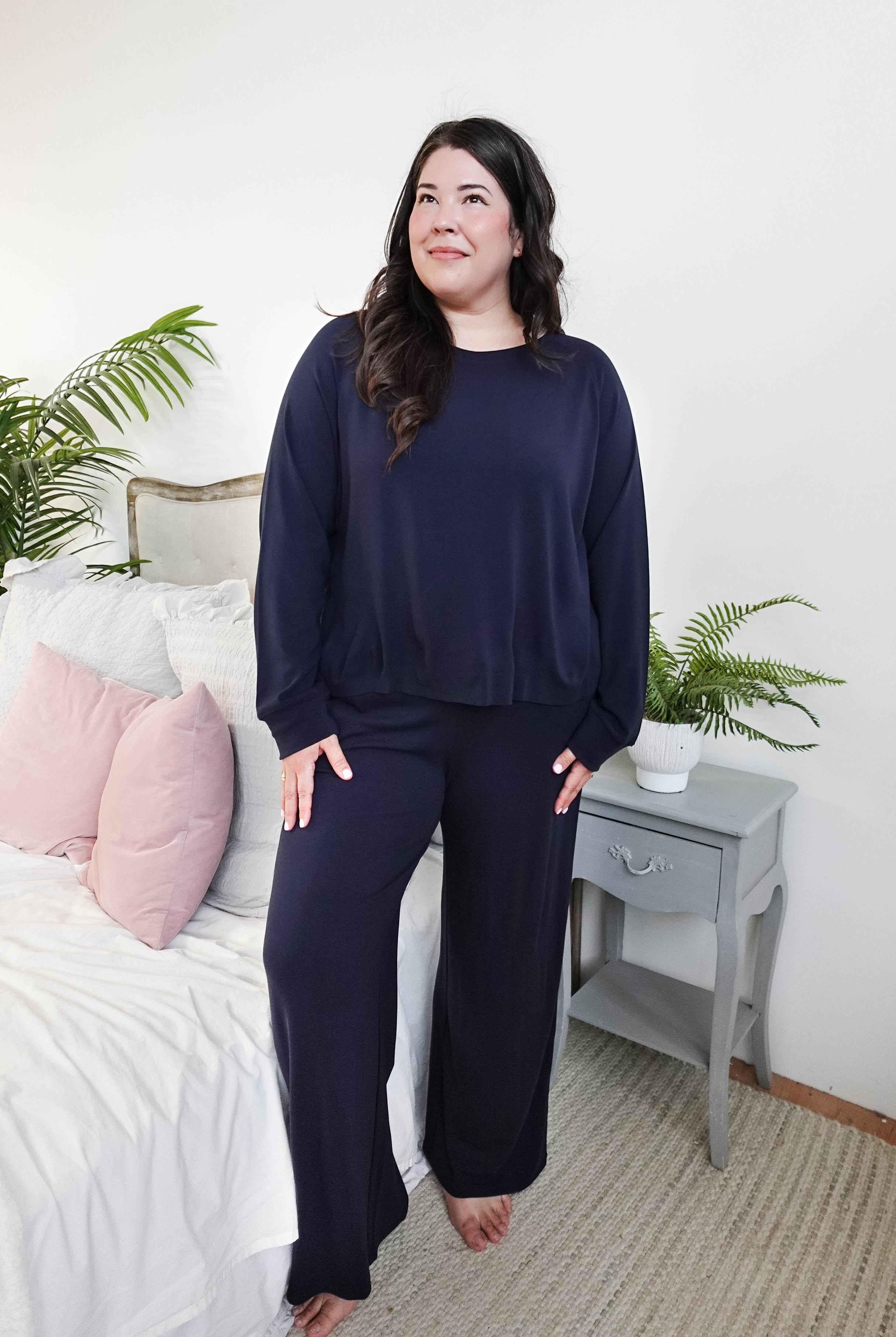 Model wearing Long Sleeve Raw Edge Straight Pant Lounge Set in navy color, styled in a cozy bedroom setting.