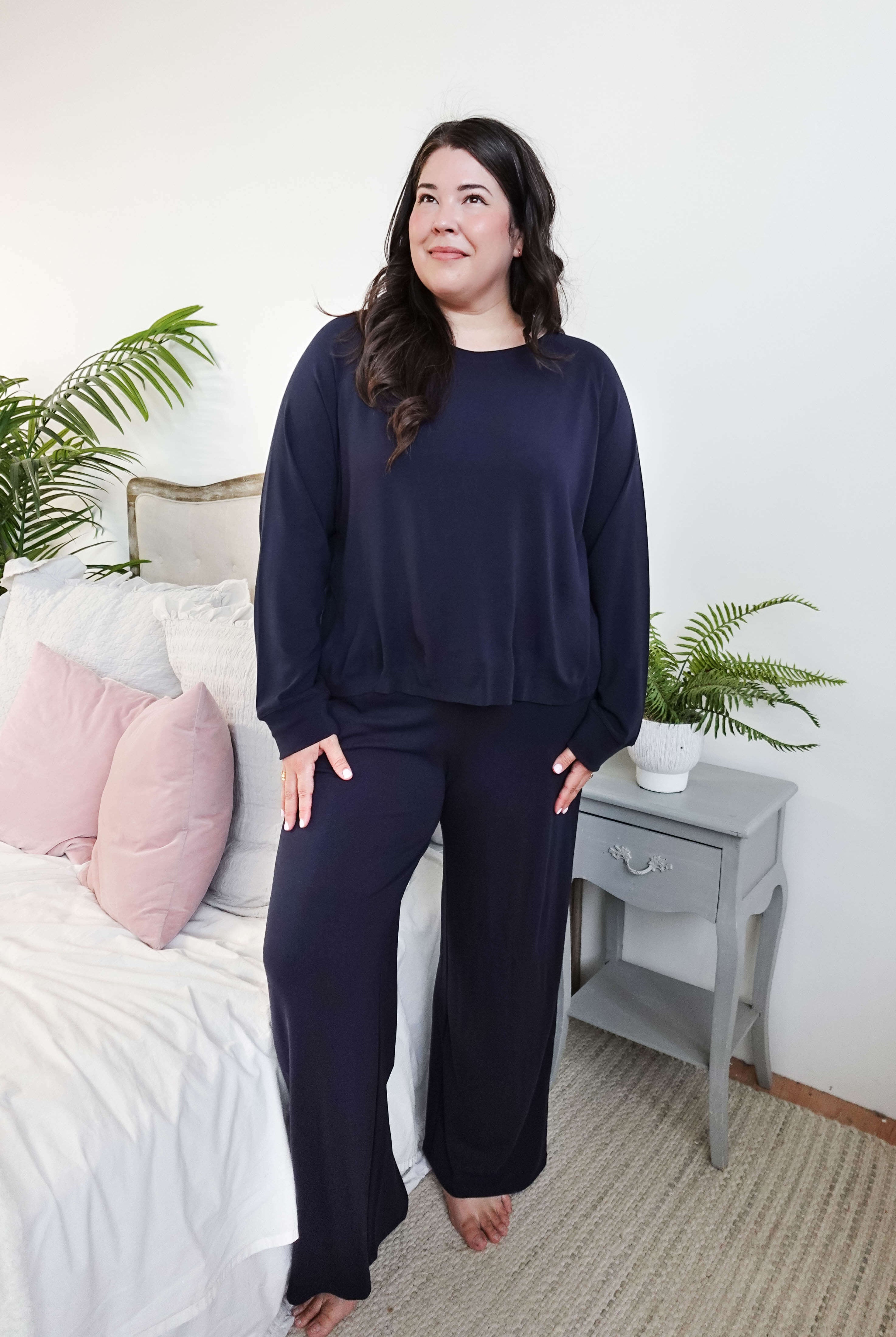 Model wearing Long Sleeve Raw Edge Straight Pant Lounge Set in navy color, styled in a cozy bedroom setting.