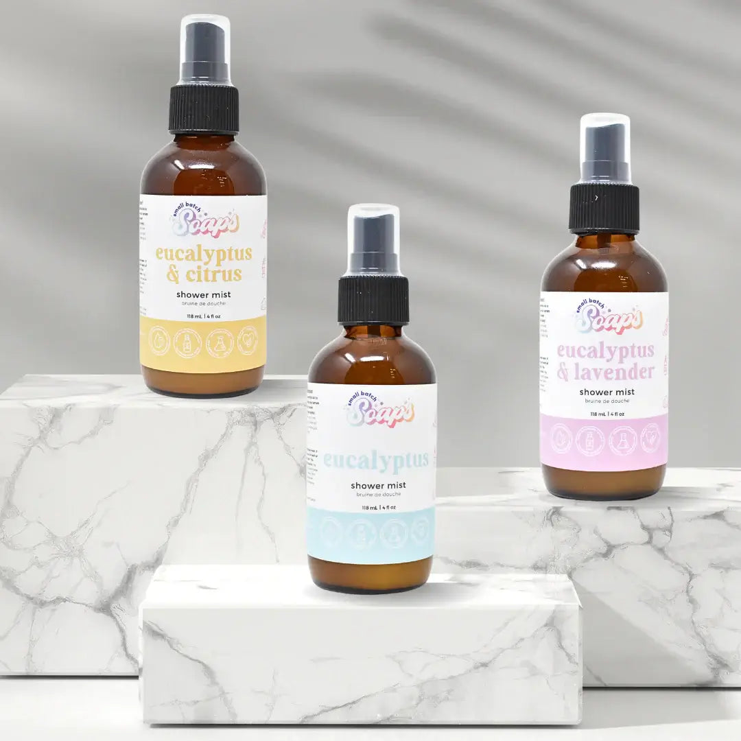 Eucalyptus Shower Mist bottles displayed on marble surface, highlighting eucalyptus & citrus, classic eucalyptus, and eucalyptus & lavender scents.