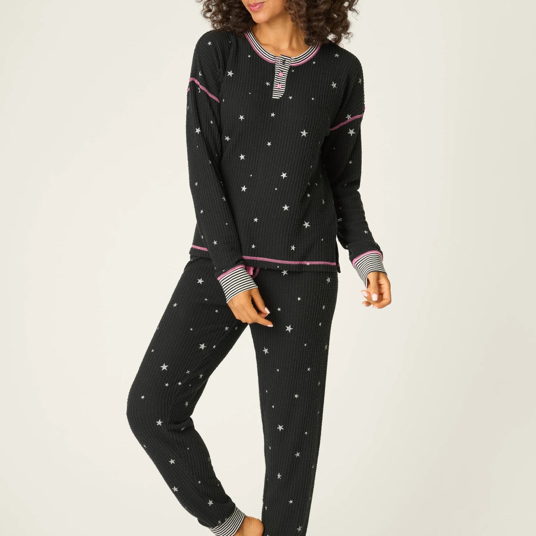 Woman wearing Ski Jammie Classics Brushed Thermal PJ Set, featuring playful winter prints in black starlight starbright star print