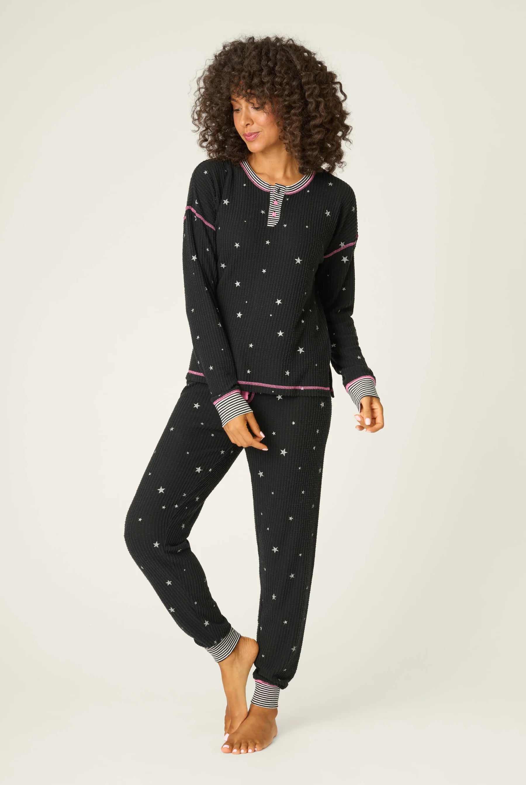 Woman wearing Ski Jammie Classics Brushed Thermal PJ Set, featuring playful winter prints in black starlight starbright star print