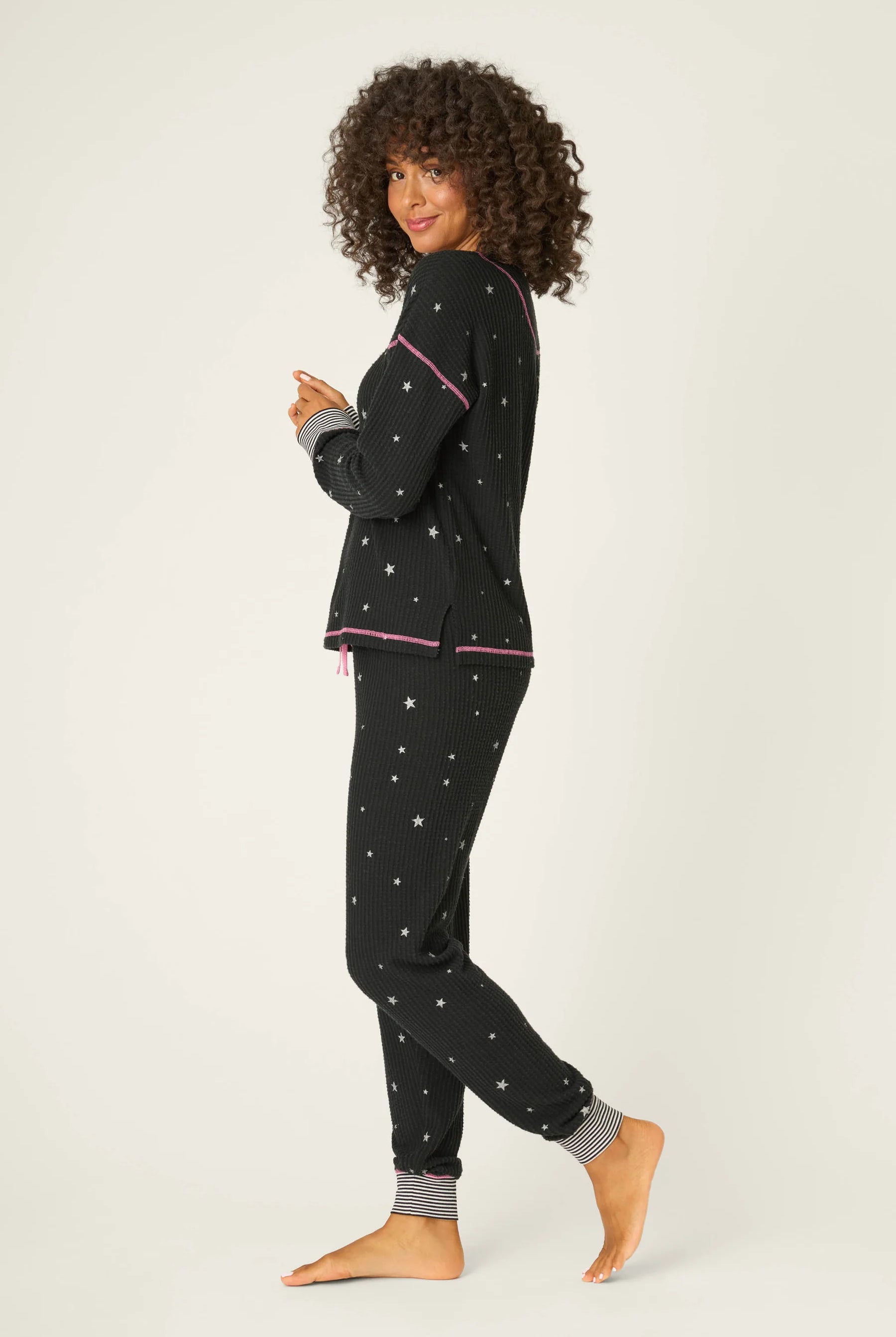 Woman wearing Ski Jammie Classics Brushed Thermal PJ Set, featuring playful winter prints in black starlight starbright star print