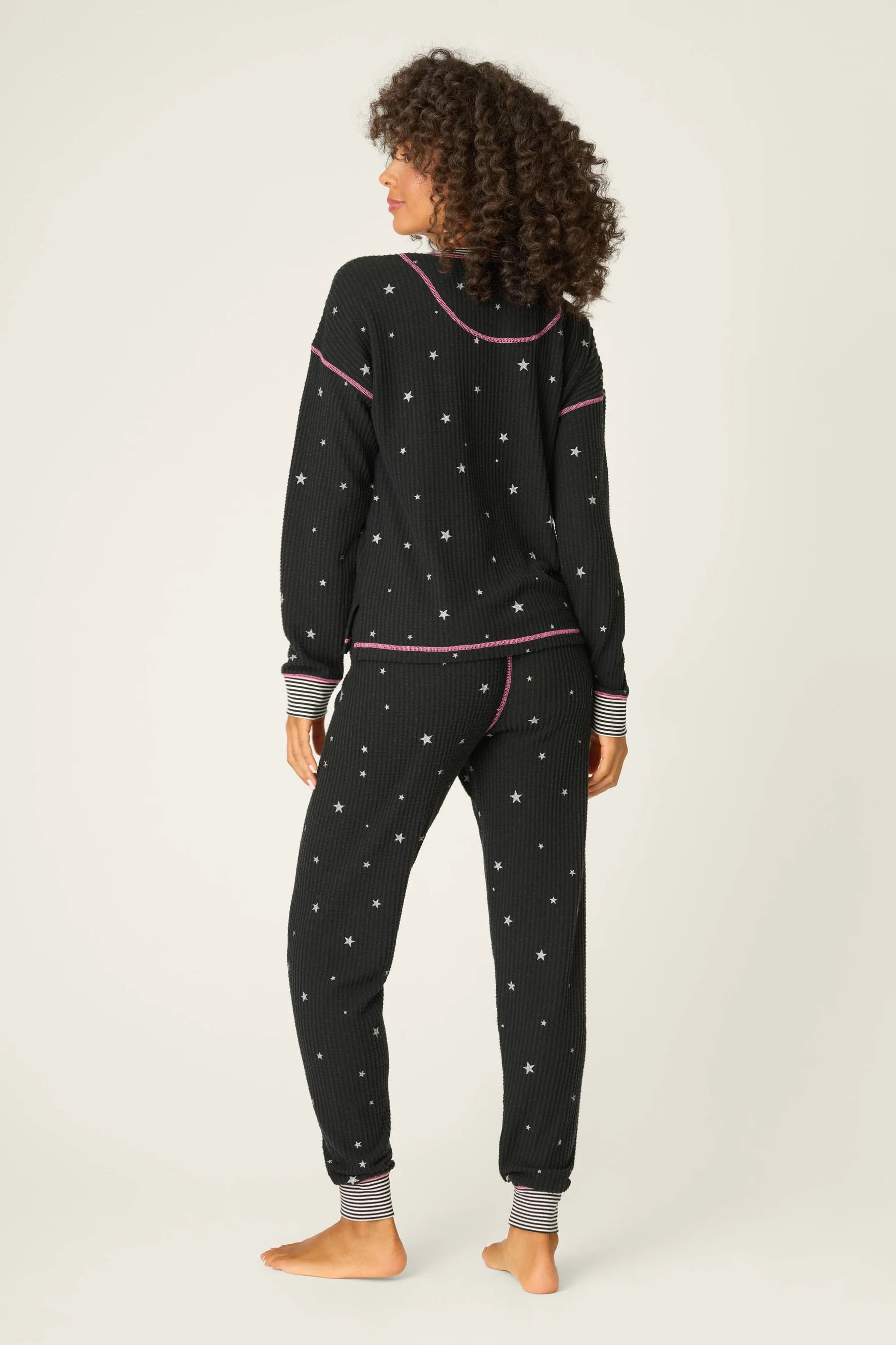 Woman wearing Ski Jammie Classics Brushed Thermal PJ Set, featuring playful winter prints in black starlight starbright star print