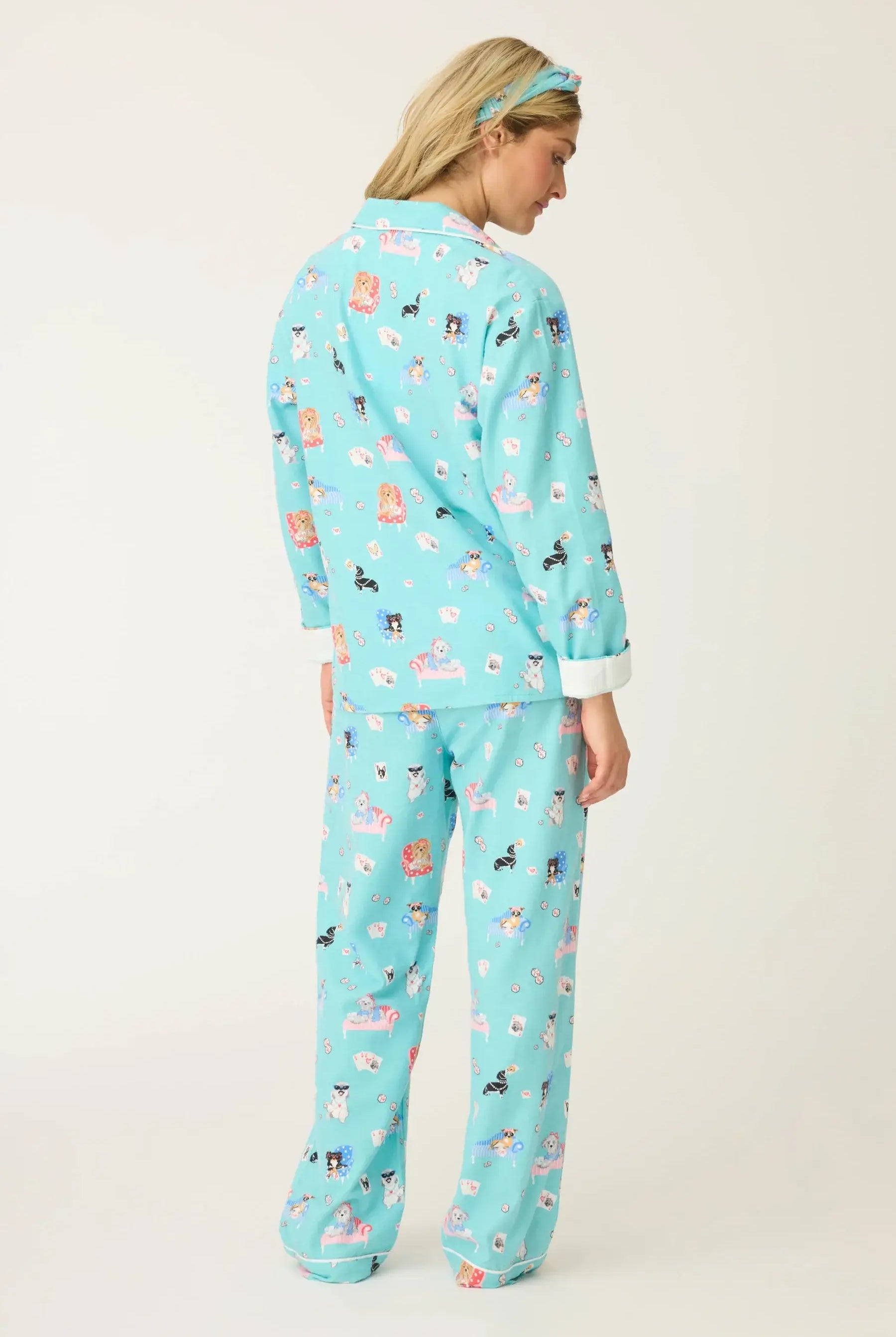 Woman wearing This Is How I Roll Dog Print Flannel PJ Set from PJ Salvage, showcasing fun dog designs in turquoise.