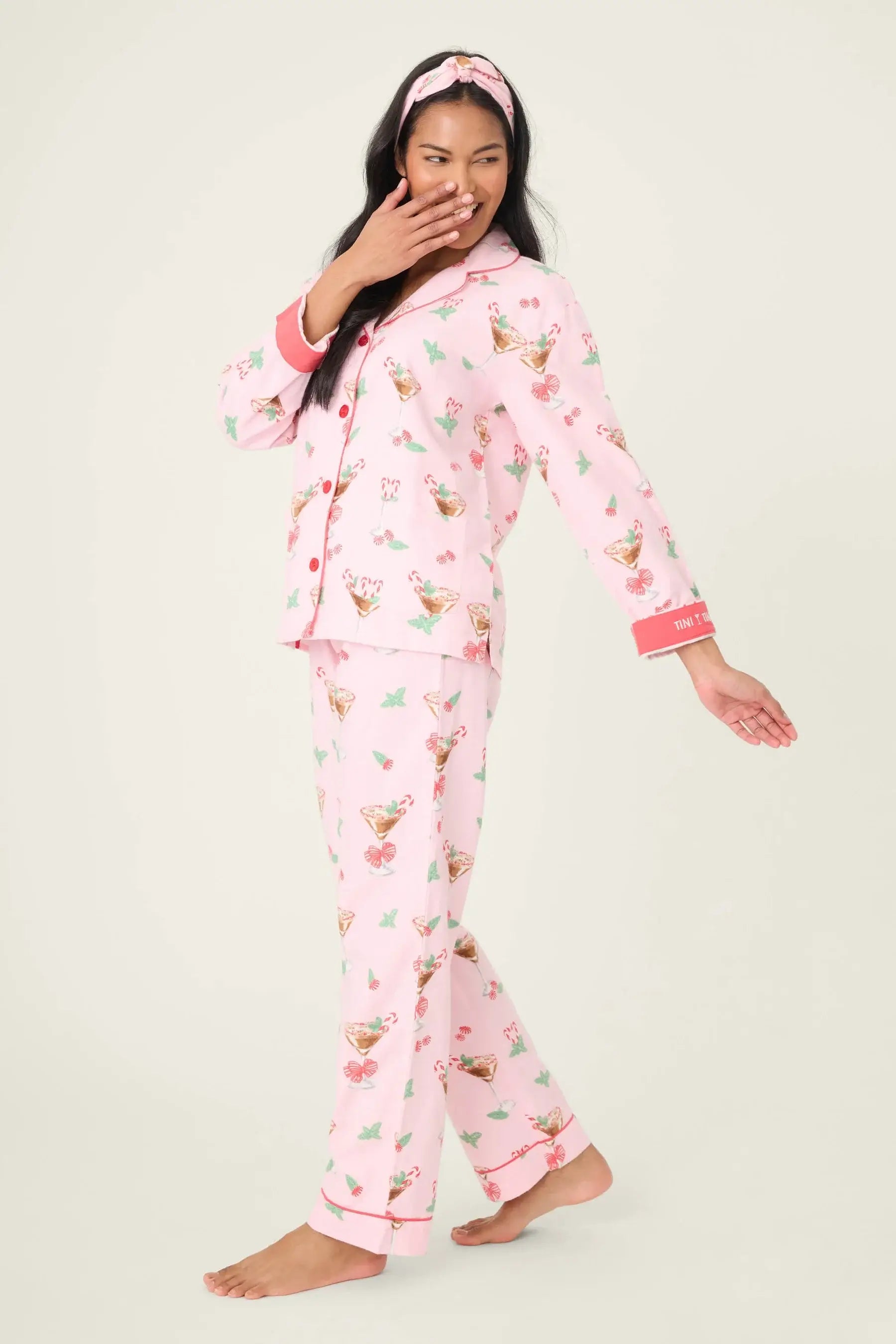 Model wearing Tini Time Drink Print Flannel 3-Piece PJ Set from PJ Salvage in pink with festive pattern.