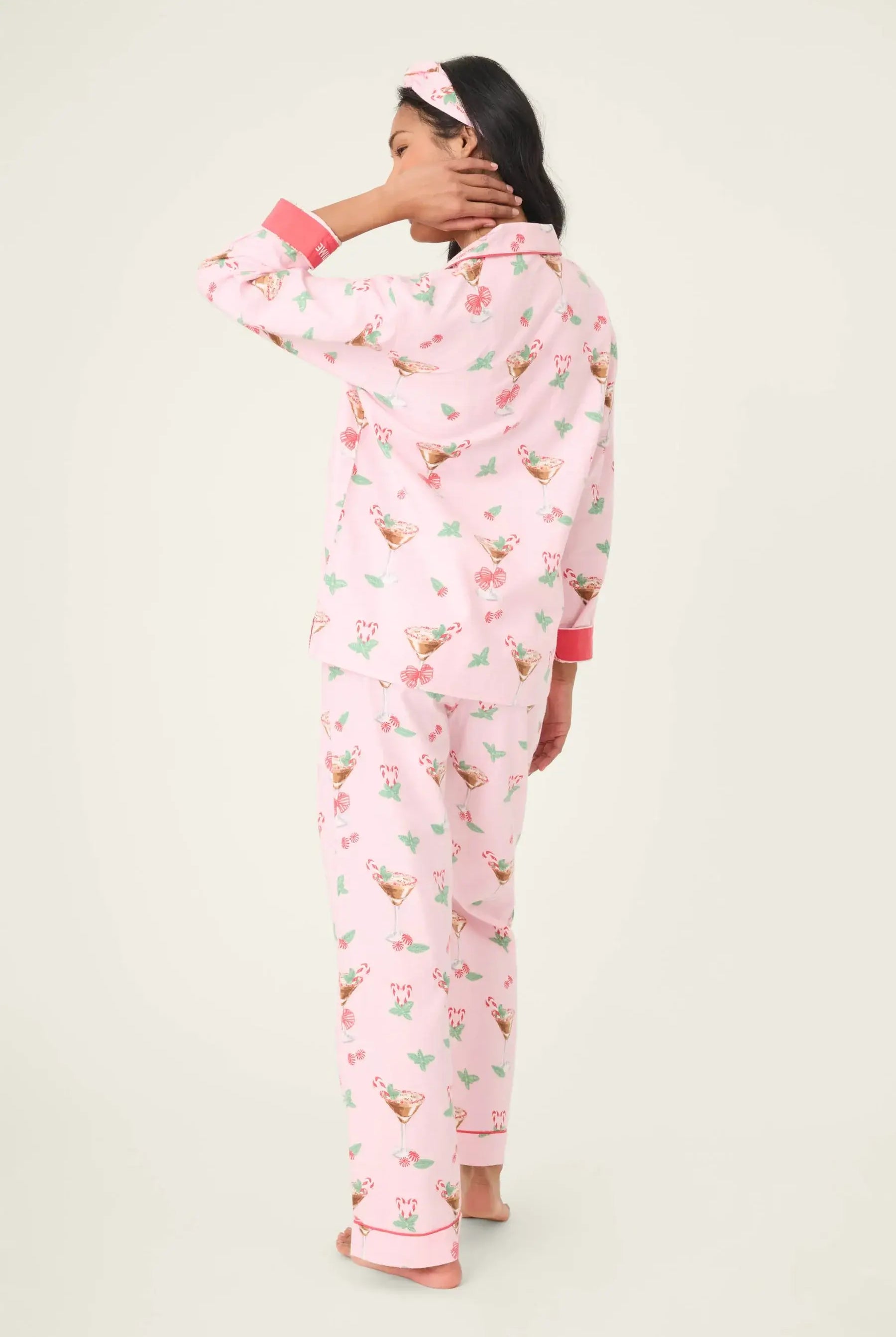 Model wearing the Tini Time Drink Print Flannel 3-Piece PJ Set from PJ Salvage, featuring a pink festive design.