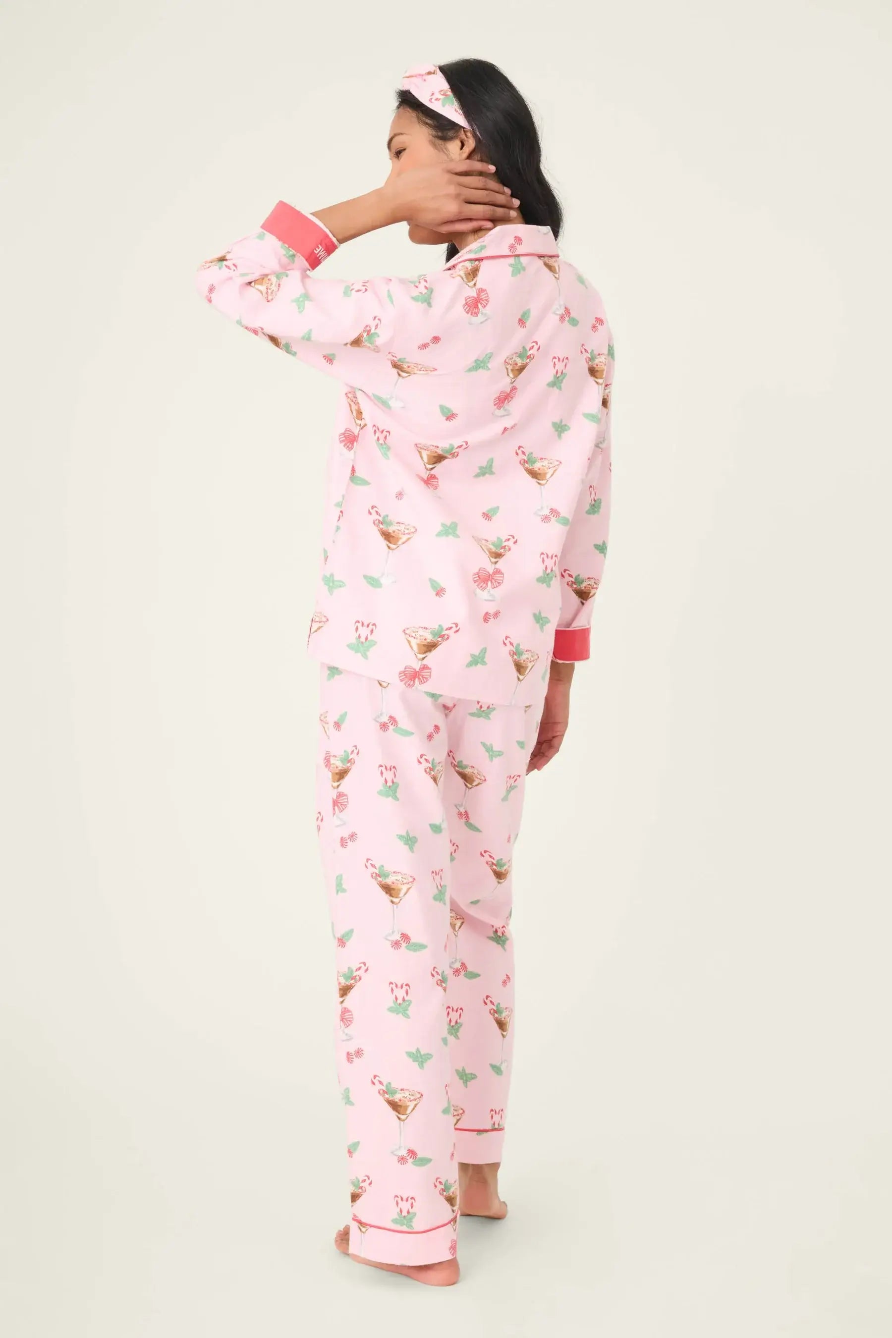 Model wearing the Tini Time Drink Print Flannel 3-Piece PJ Set from PJ Salvage, featuring a pink festive design.