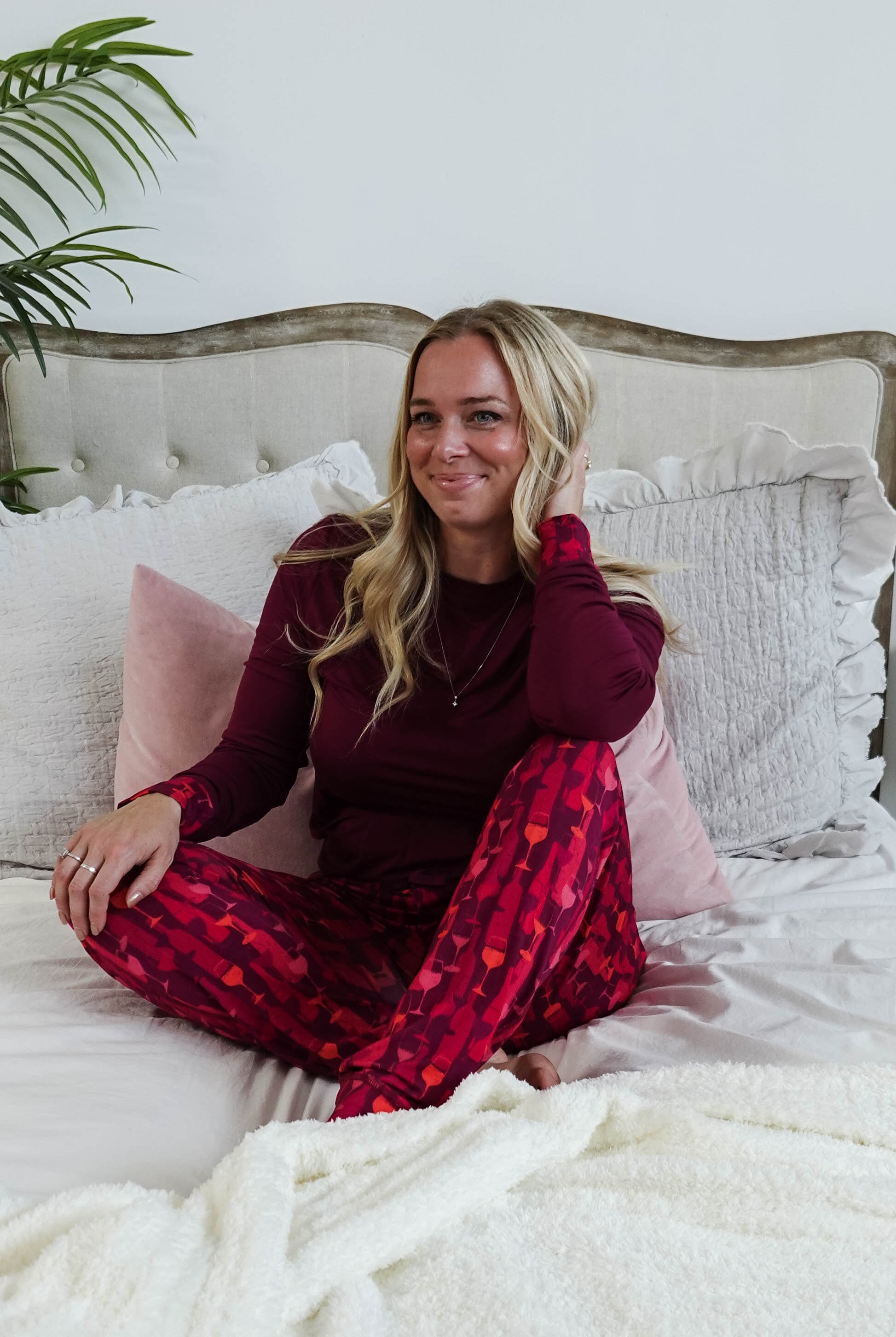 Vino Dreams PJ Long Sleeve Jogger Bamboo Set | GEORGIA RYLAN - model sits on bed wearing the set