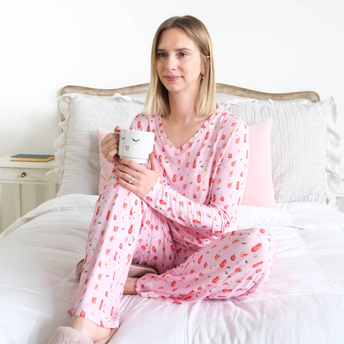Georgia Rylan Cozy Cocktails V-Neck Bamboo PJ Set lifestyle front view seated on bed — Cloud Nine Pajamas Edmonton