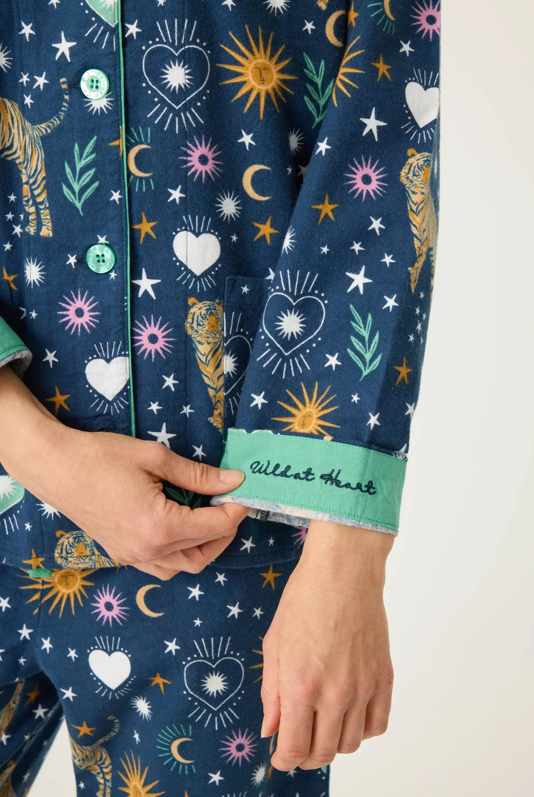 Close-up of Wild At Heart 3-Piece Flannel PJ Set with colorful patterns and embroidered cuff detail.