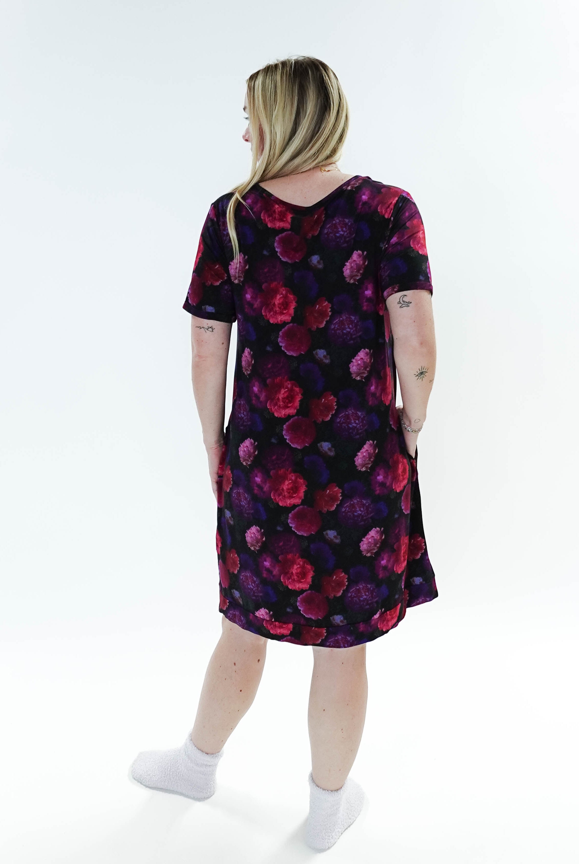 Model wearing the Winter Blossom V Neck Bamboo Nightshirt with Pockets, showing back. Features colorful floral print.