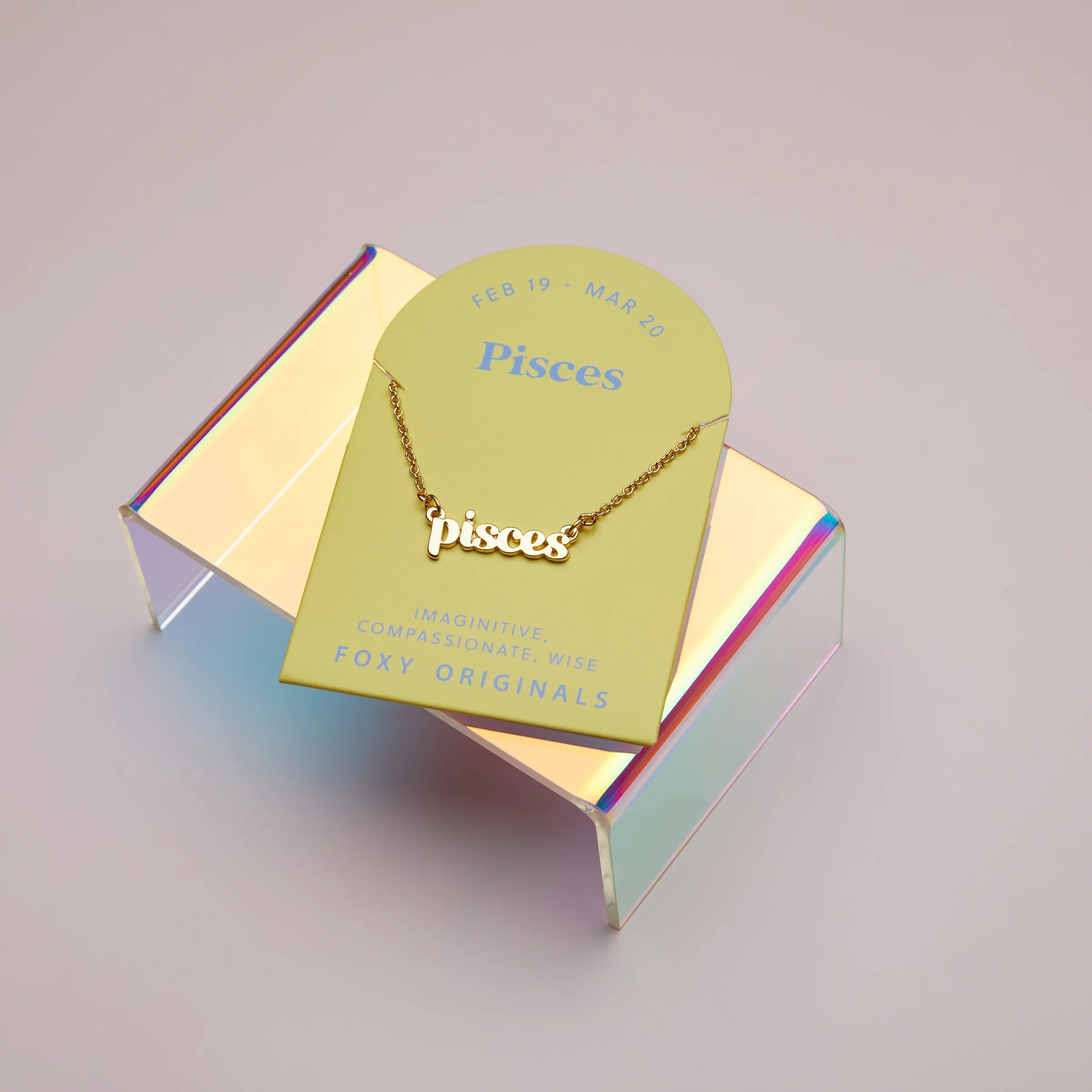 Zodiac Script Necklace in 14K Plated Gold featuring the Pisces astrological sign on a bright yellow display card.