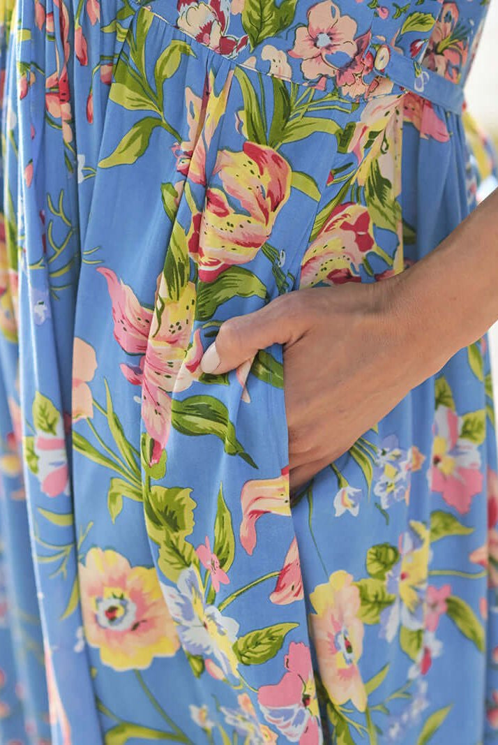 Close-up of April Cornell Lillian Rayon Dress showcasing its blue floral pattern and pockets.