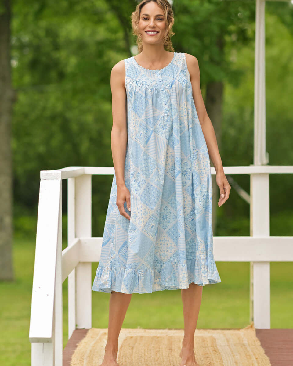 April Cornell Maddie’s Medley Cotton Nightgown – Embroidered Light Blue Sleeveless Nighty with Button Front. Worn by a model in a cottage/outdoor setting