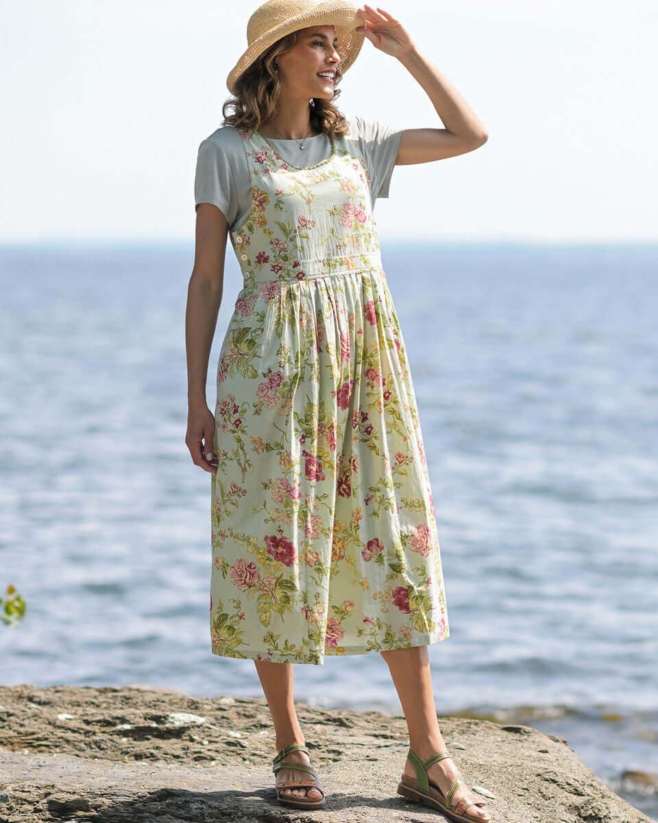 April Cornell Milene Cotton Pinafore Midi Dress Sage Green with Hand-Crochet Neckline model show on a rocky beach