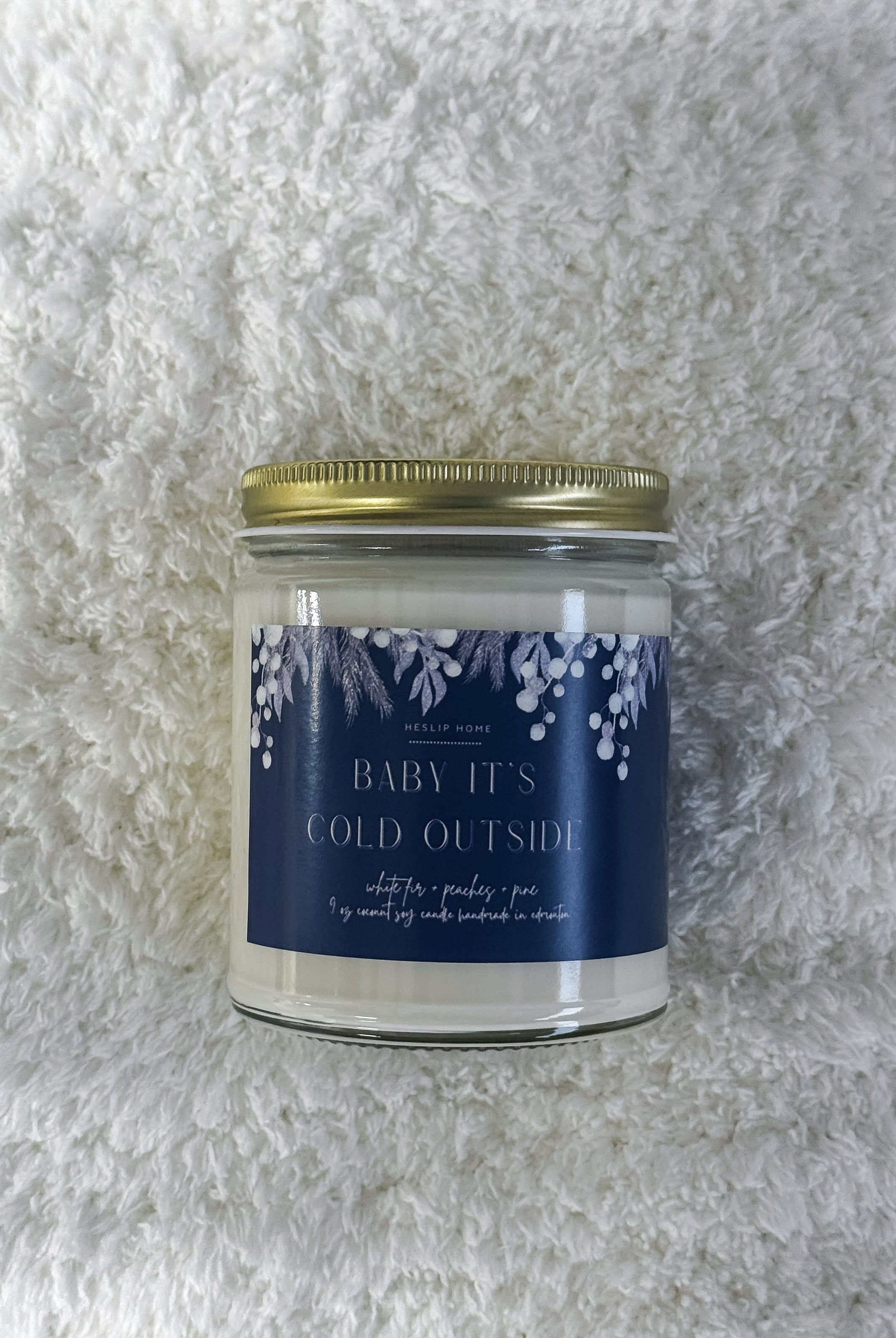 baby its cold outside candle with notes of the woods - fir and pine - plus sweet peaches
