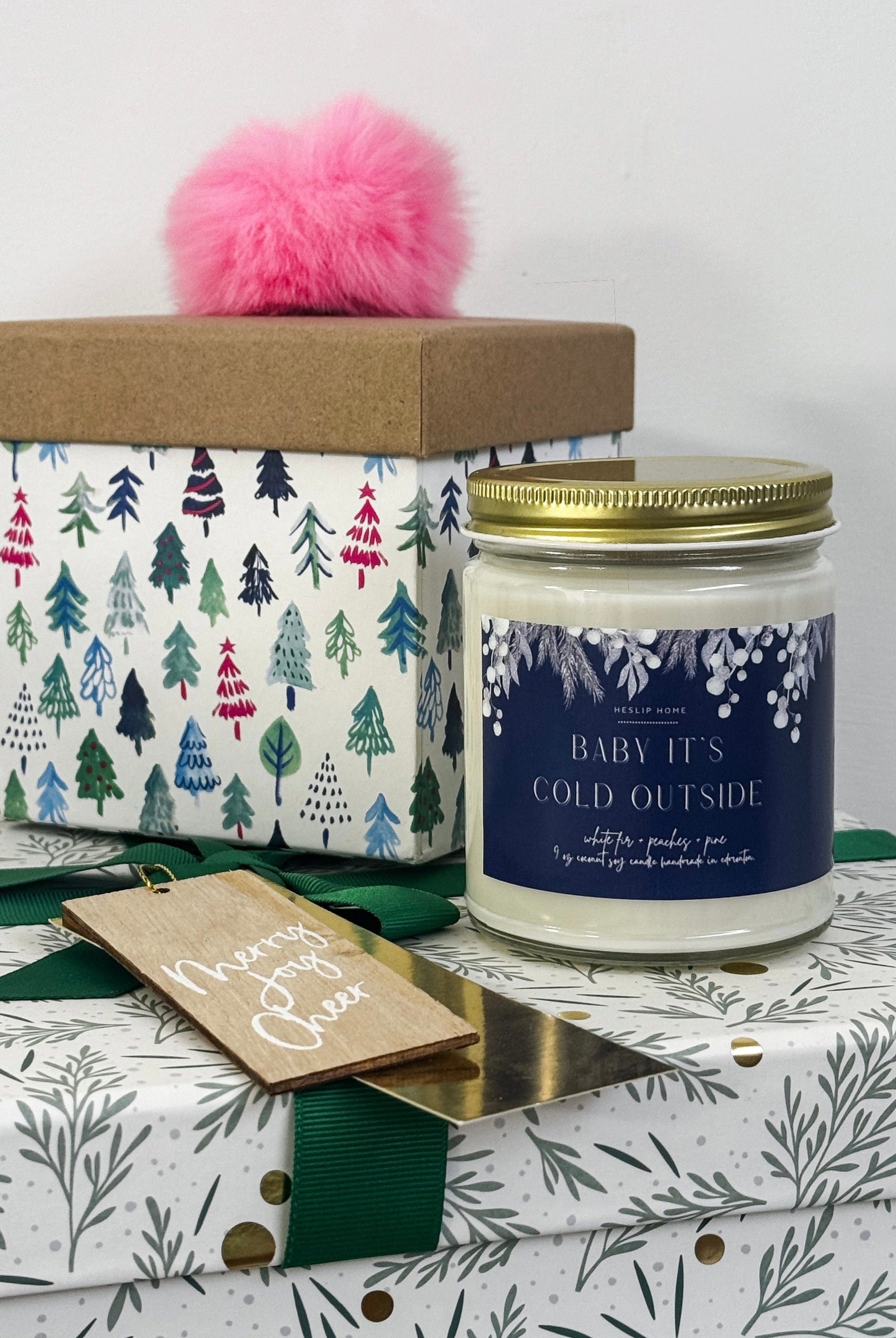 baby its cold outside candle with notes of the woods - fir and pine - plus sweet peaches
