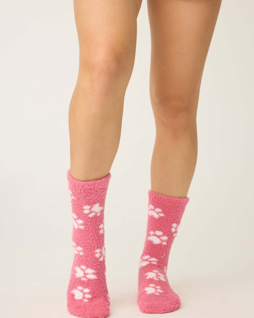 Pair of PJ Salvage Pink Fuzzy Cozy Socks with the adorable all-over paw print design. Showing the plush texture and mid-height crew cut.