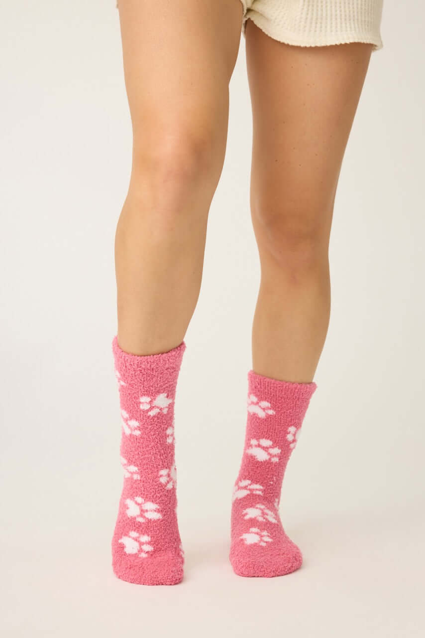 Pair of PJ Salvage Pink Fuzzy Cozy Socks with the adorable all-over paw print design. Showing the plush texture and mid-height crew cut.