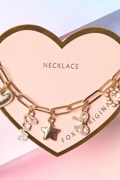 Bella Charm Necklace in 14K Gold featuring heart, star, bow, love script, and pearl charms on a gold chain.