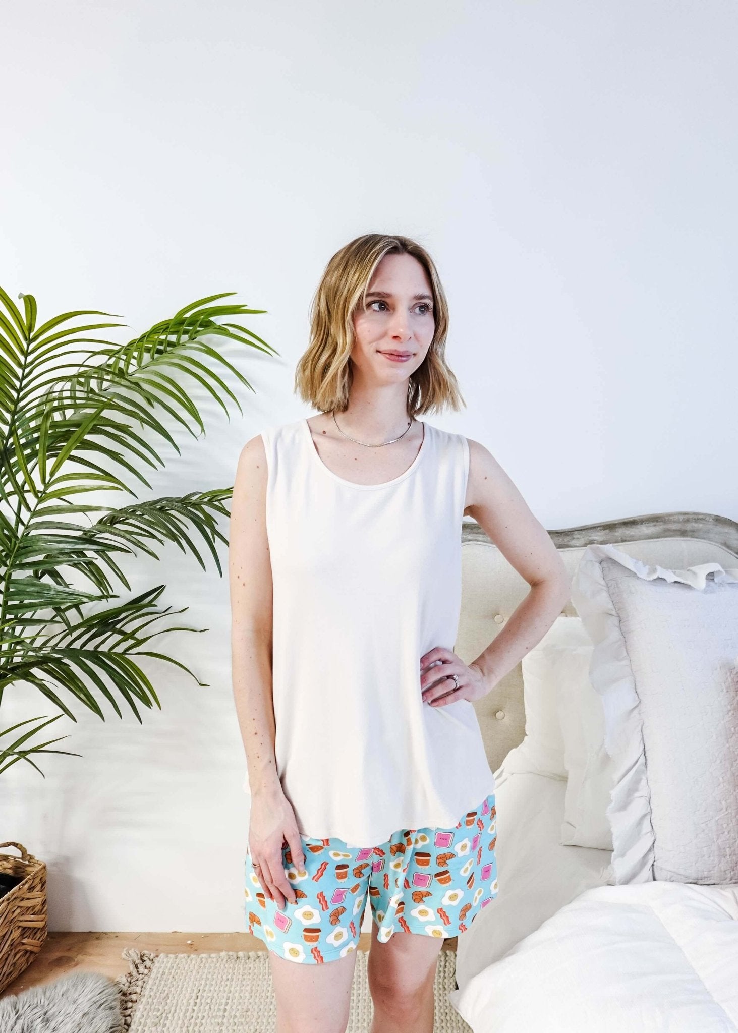Front View of Miranda wearing the Brunch Club velour shorts with eggs and bacon print and ivory peachy tank.