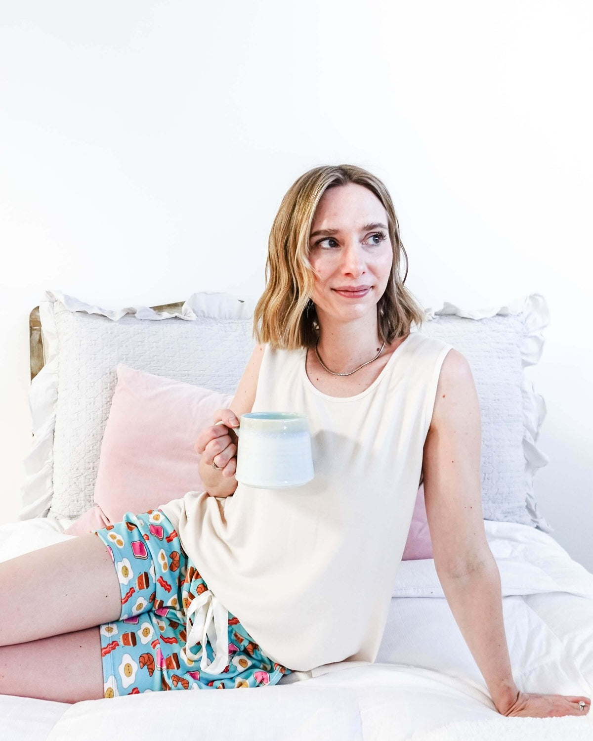 Miranda Nic Brunch Club Breakfast Print Velour Short Set lifestyle on bed — Cloud Nine Pajamas Edmonton