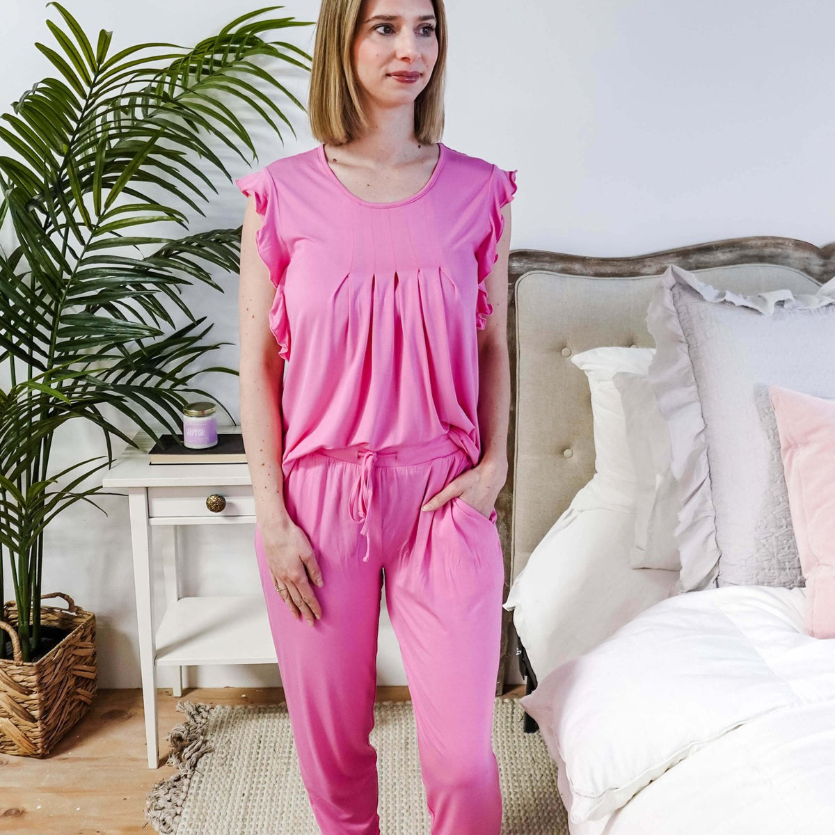 Bubblegum Pink Flutter Top and Jogger Bamboo PJ Lounge Set worn by a model in a cozy bedroom setting.