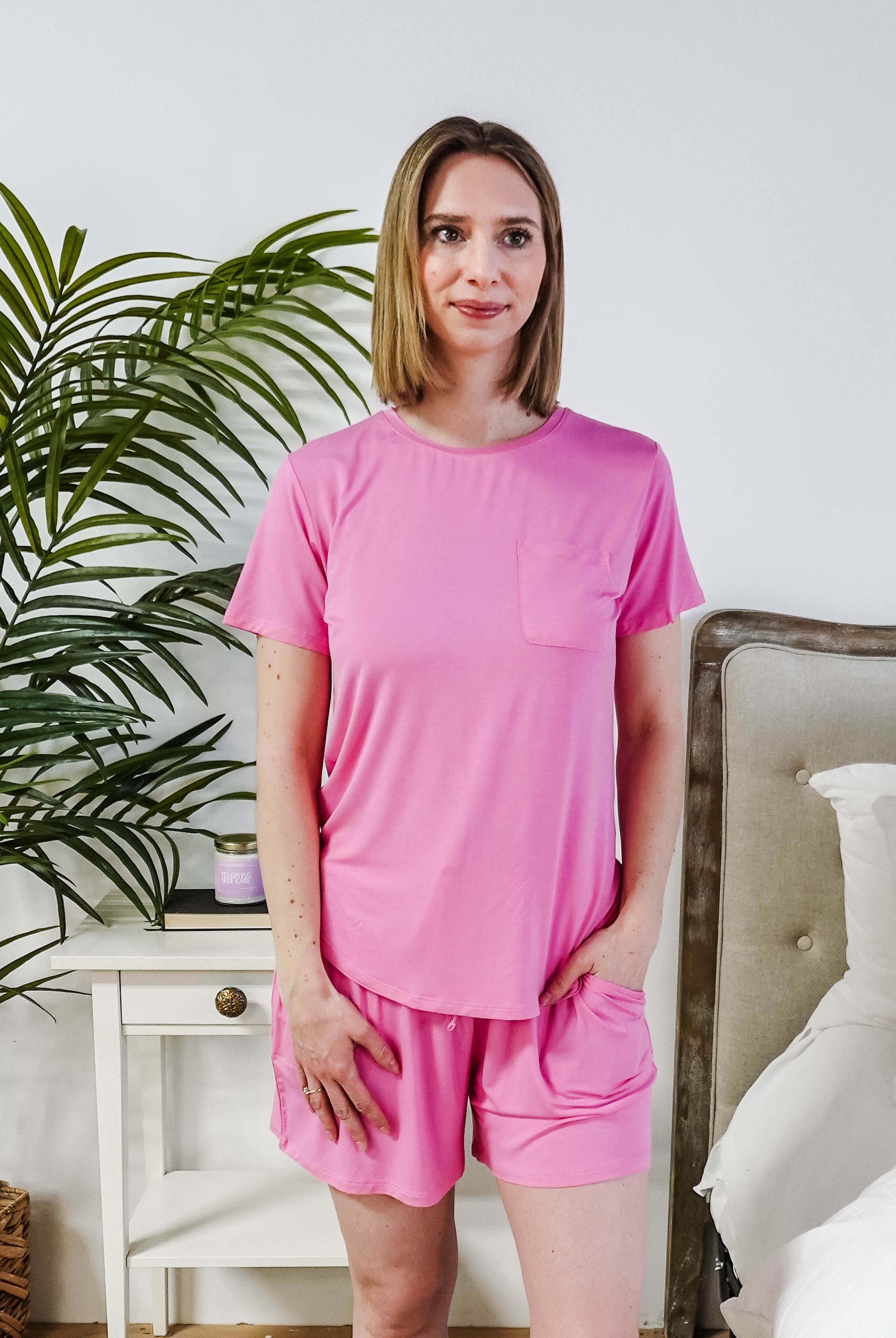 Model wearing a Bubblegum Pink Tee Short Bamboo Pajama Set, featuring a stylish pocket and comfortable fit.