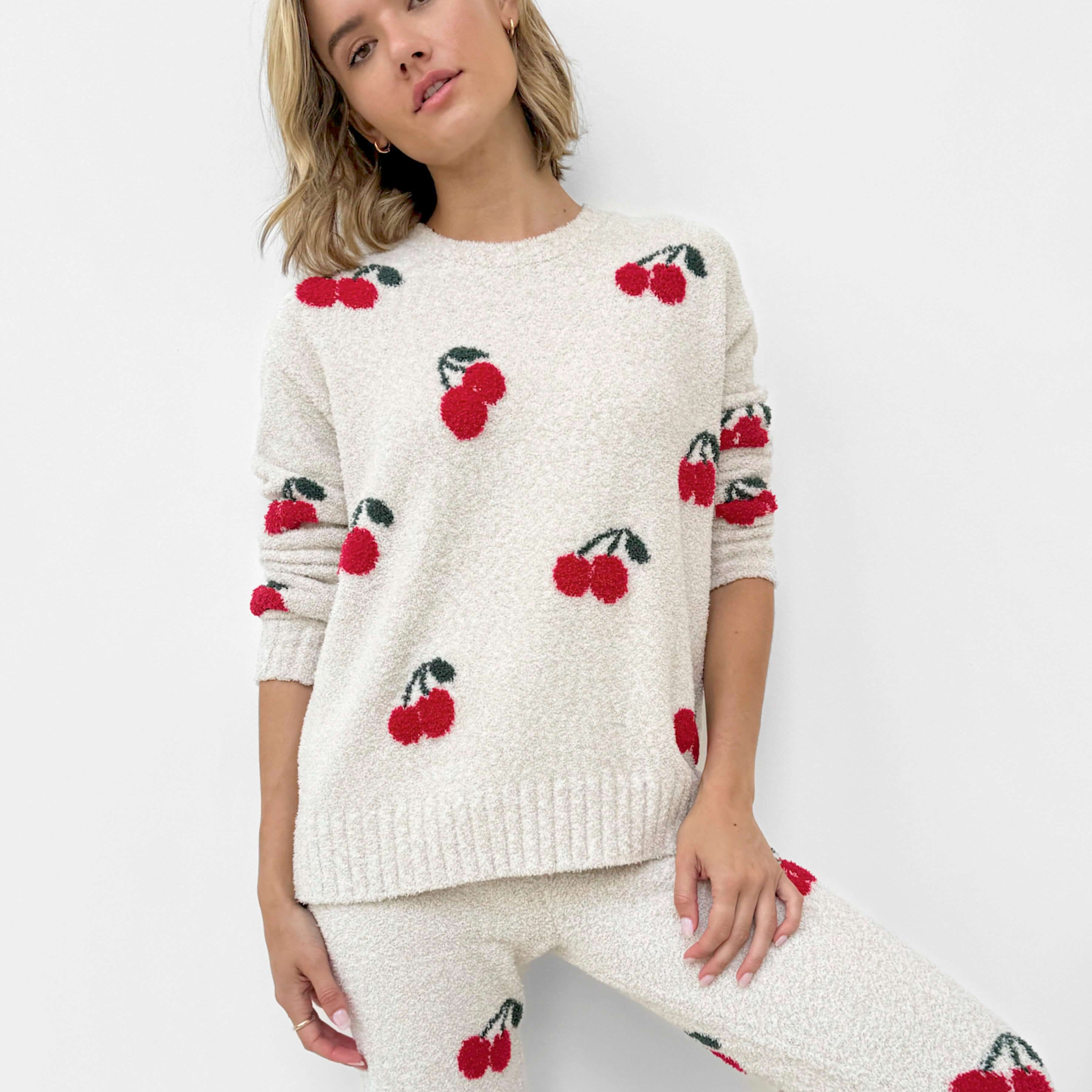 Woman wearing a Cloud-Soft Fuzzy Sweater Pajama Set Splendid with cherry patterns, showcasing cozy loungewear style.