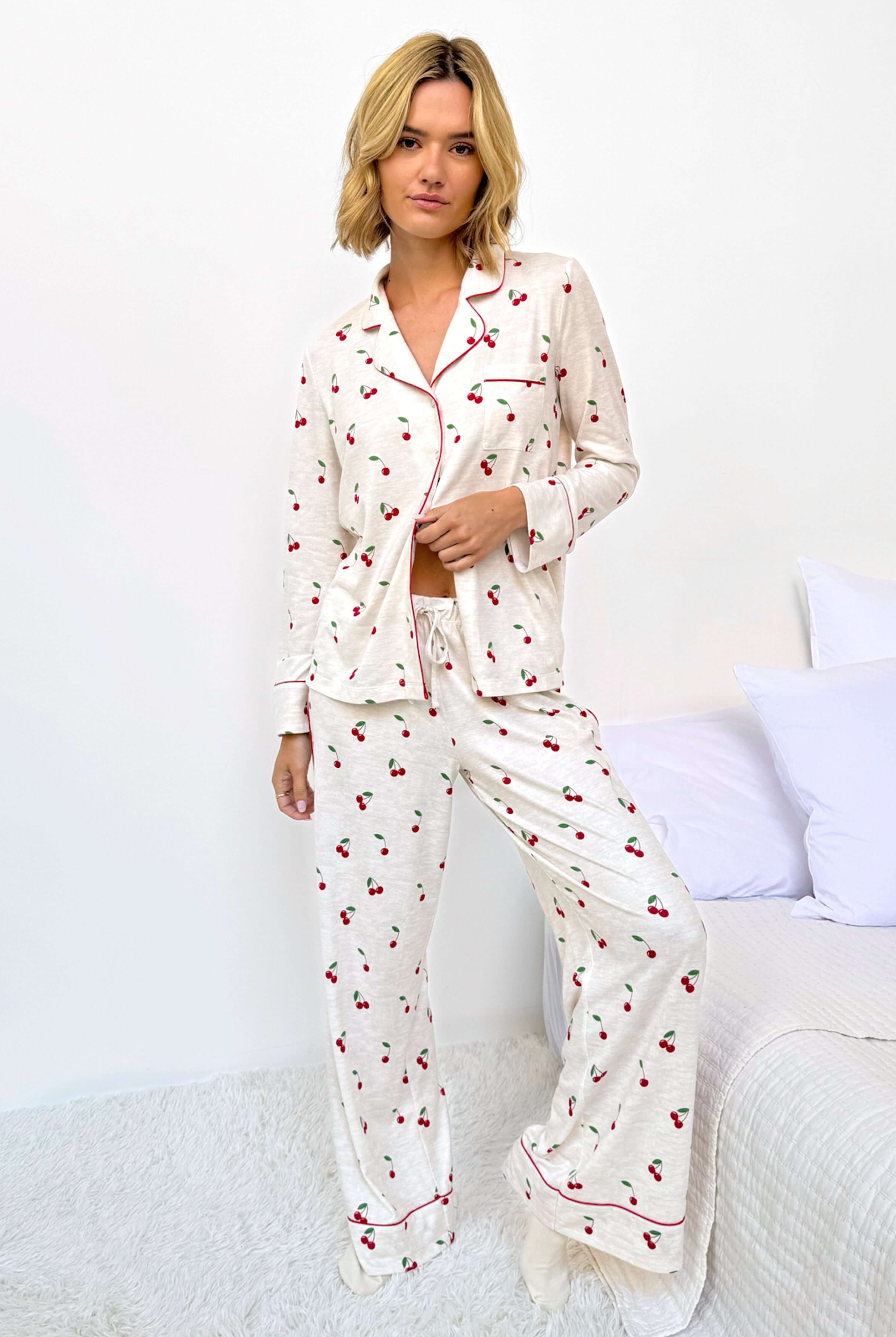 Model wearing the Flora Pillowsoft Sleep Set Splendid, featuring silky soft button-down pajamas with a cherry design.