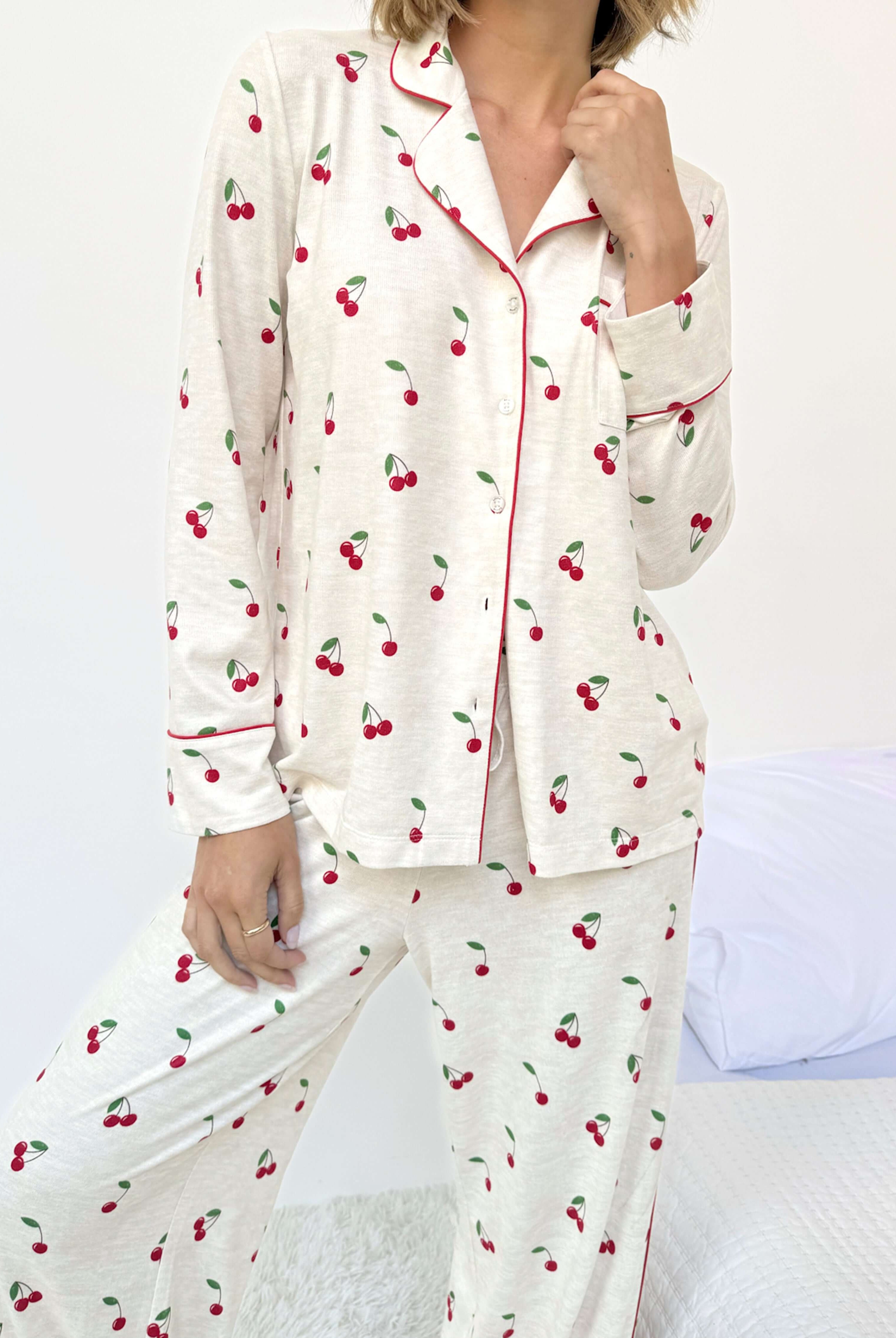 Model wearing the Flora Pillowsoft Sleep Set Splendid, featuring silky soft button-down pajamas with a cherry design.