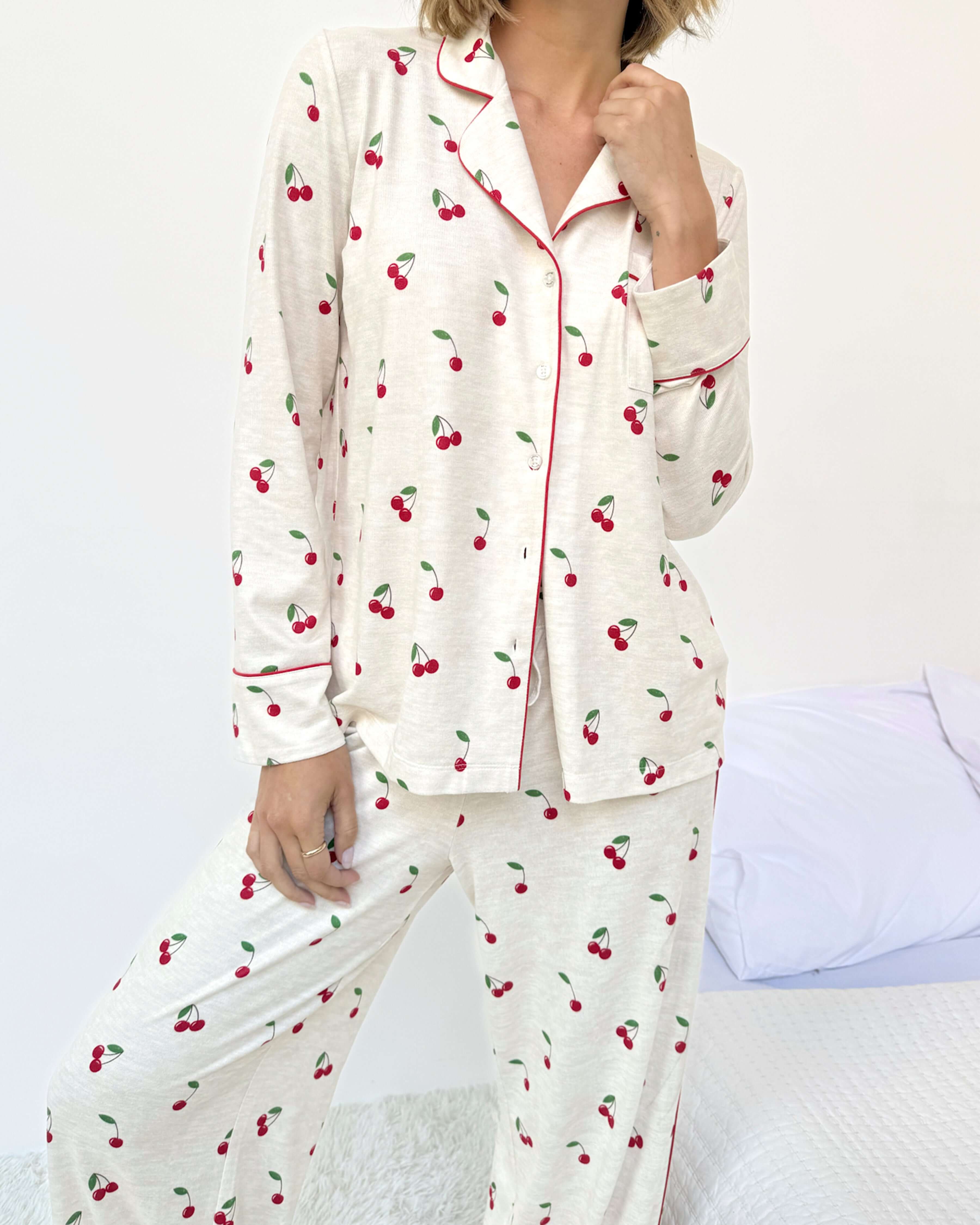 Model wearing the Flora Pillowsoft Sleep Set Splendid, featuring silky soft button-down pajamas with a cherry design.