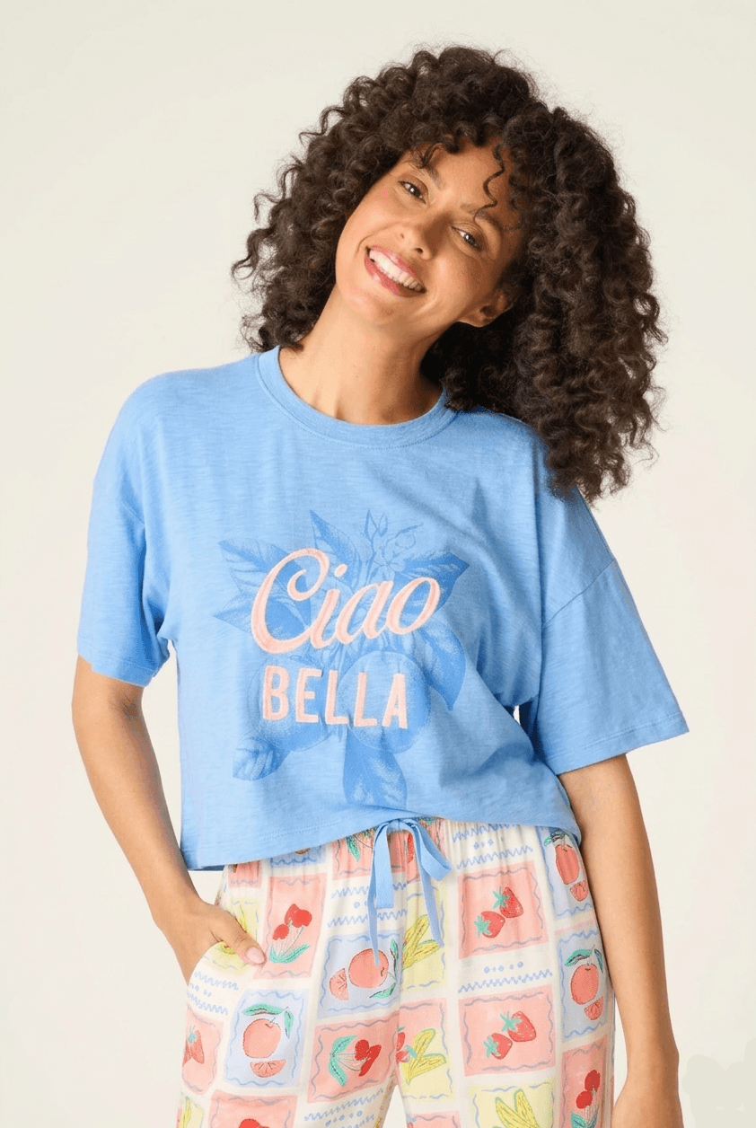 Frutta Fresca Ciao Bella Fruit Print PJ Set by PJ Salvage model wearing blue tee and colorful pajama bottoms.