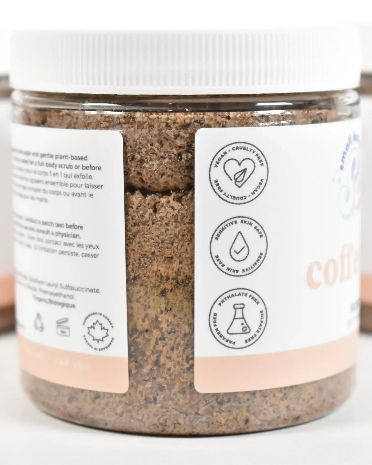 Coffee Bean Sugar Scrub jar with labels highlighting key ingredients and benefits.