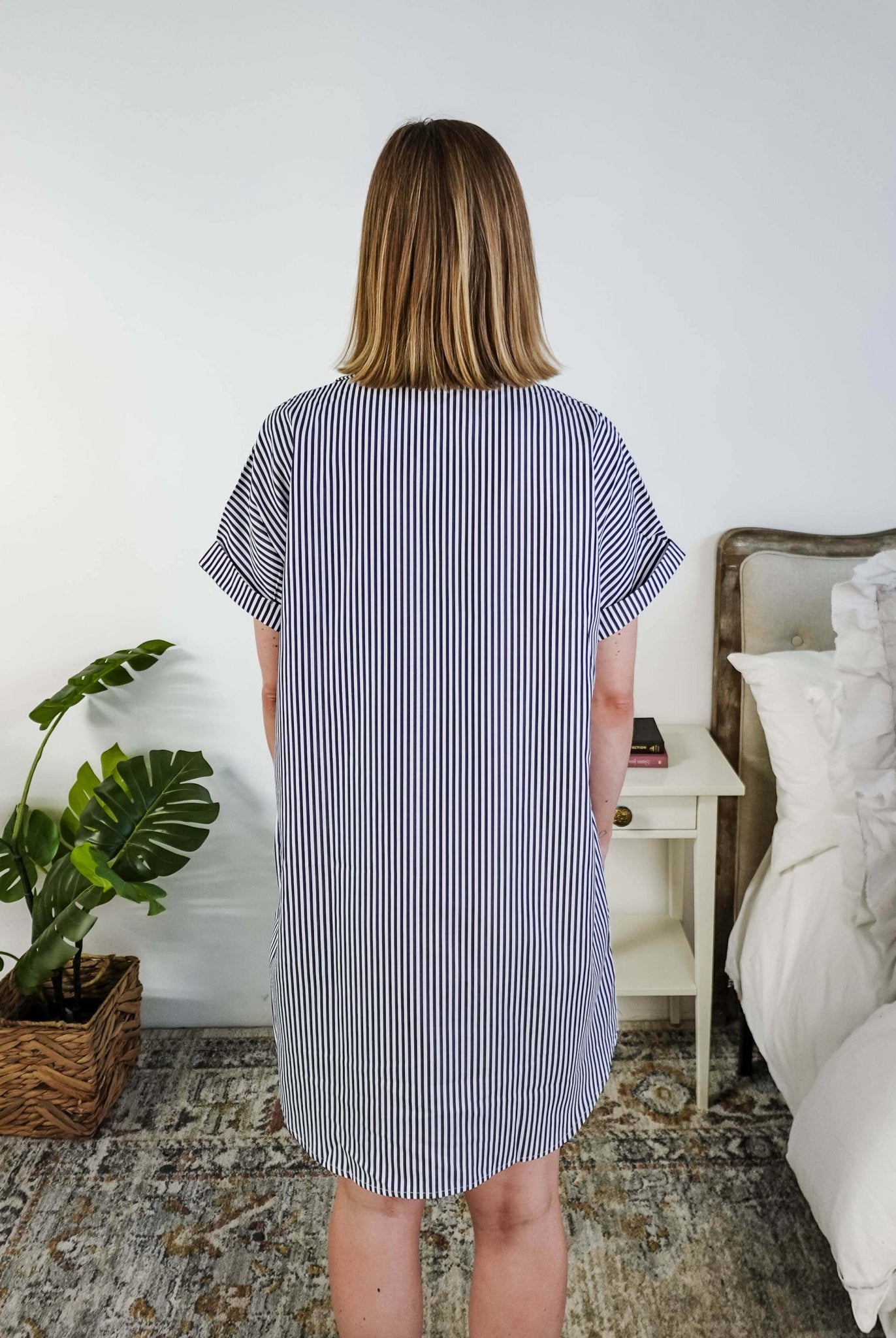 Person wearing a blue and white striped dress in a bedroom setting, Scarlett Ellie Collared Button-Up Short Sleeve Dress | Cloud Nine Pajamas