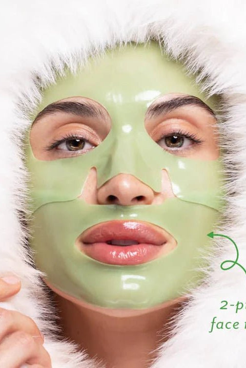 Person wearing a green face mask with a white fur-lined hood on a light background, Patchology Cool Crush cryo-inspired hydrogel face mask depuffing
