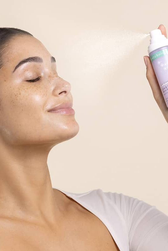 Cozy Comforts Soothing & Protecting Skincare Essential Kit Patchology spray application on glowing skin.