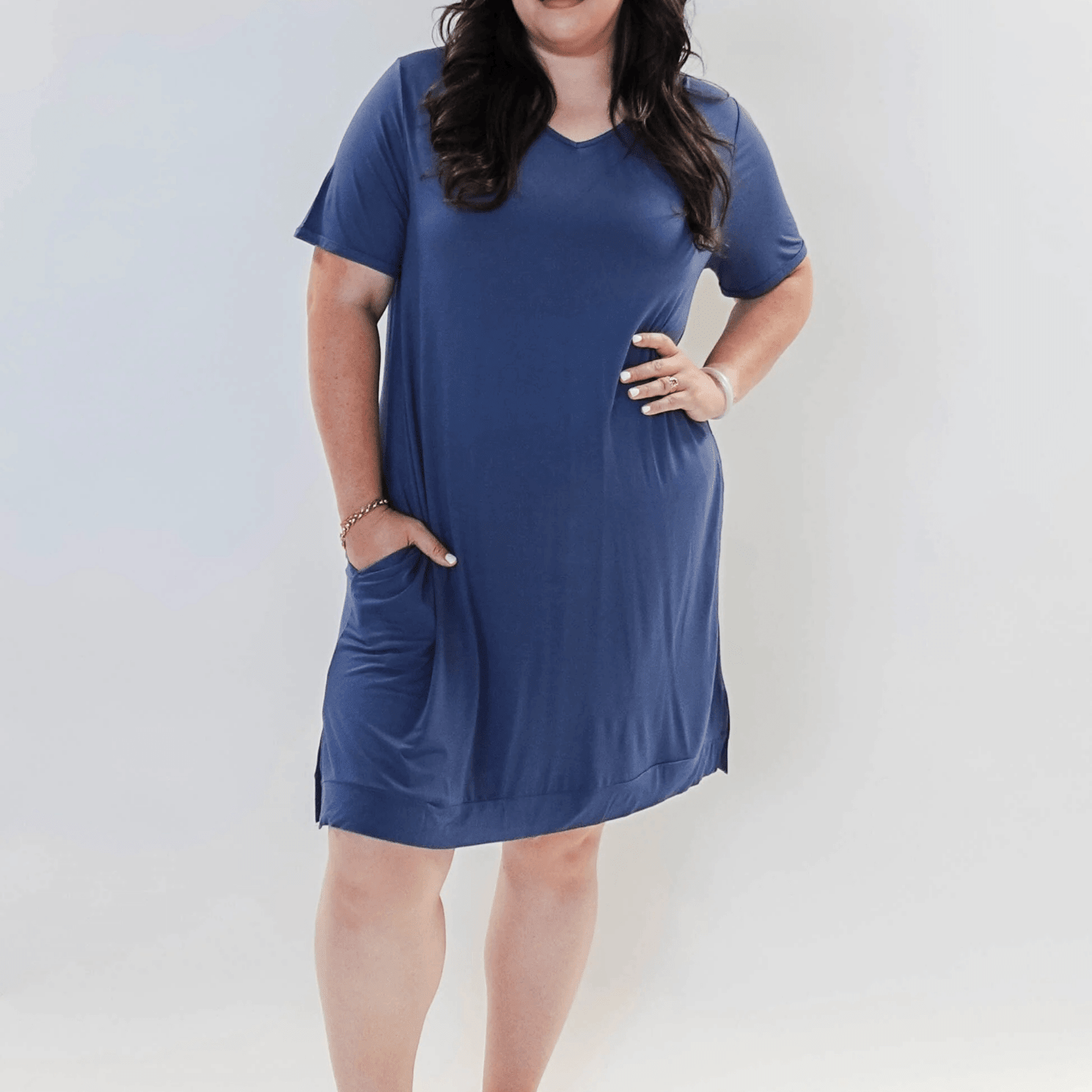 Stylish model wearing Denim Blue V Neck Bamboo Nightshirt dress with pockets, showcasing versatility in sleepwear and everyday fashion.