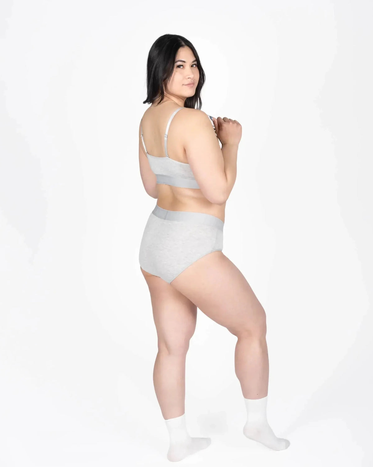 Model wearing Devon + Lang Bria Full Coverage Bikini Brief and matching bralette in gray.