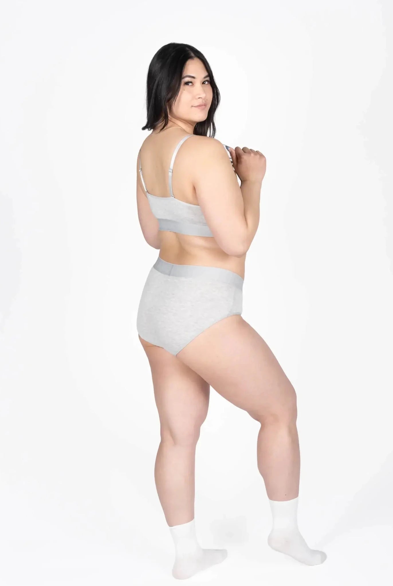 Model wearing Devon + Lang Bria Full Coverage Bikini Brief and matching bralette in gray.